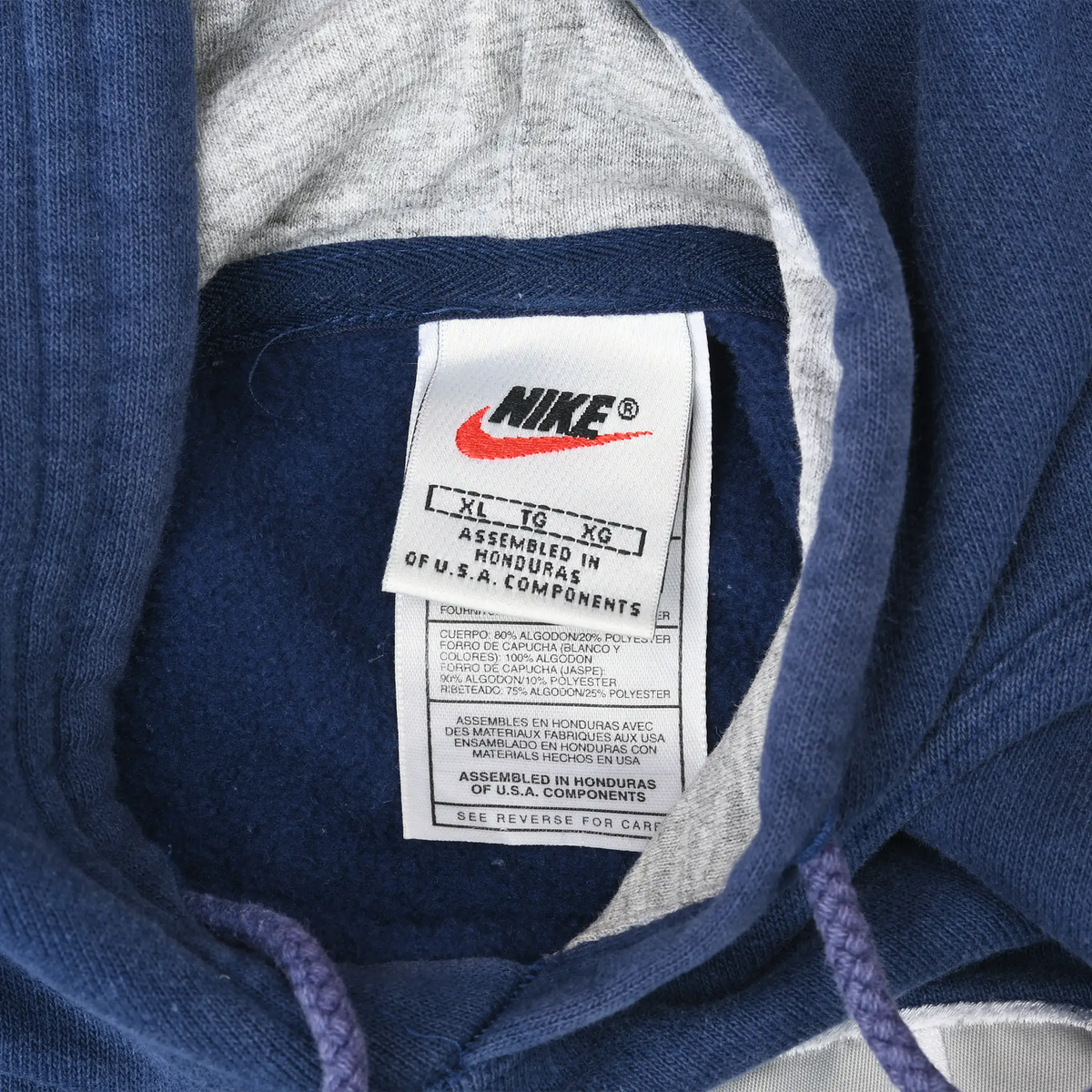 Close-up of Nike neck label marked XL inside the navy blue hoodie