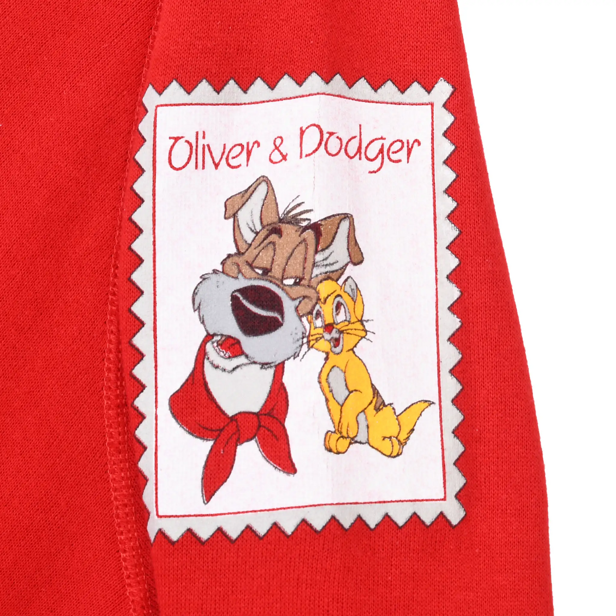 Oliver & Dodger character patch on red sweatshirt sleeve