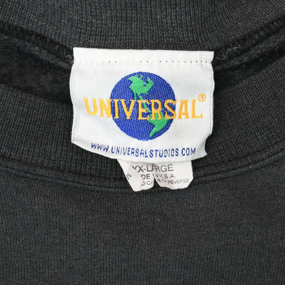 Close-up of Universal globe neck label on black sweatshirt