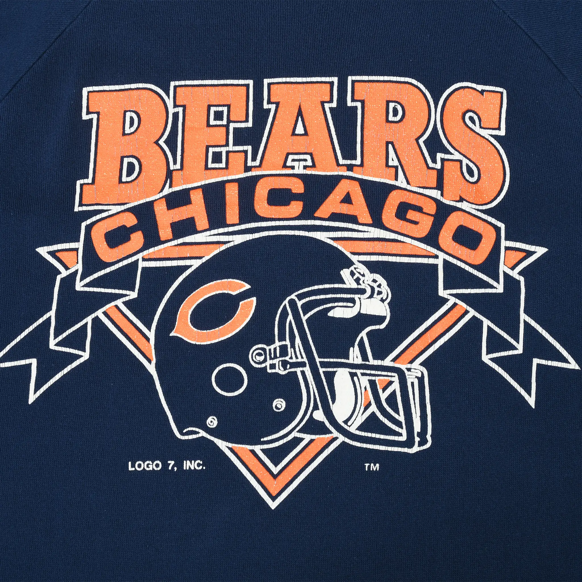 Close-up of orange and white Chicago Bears text and football helmet graphic