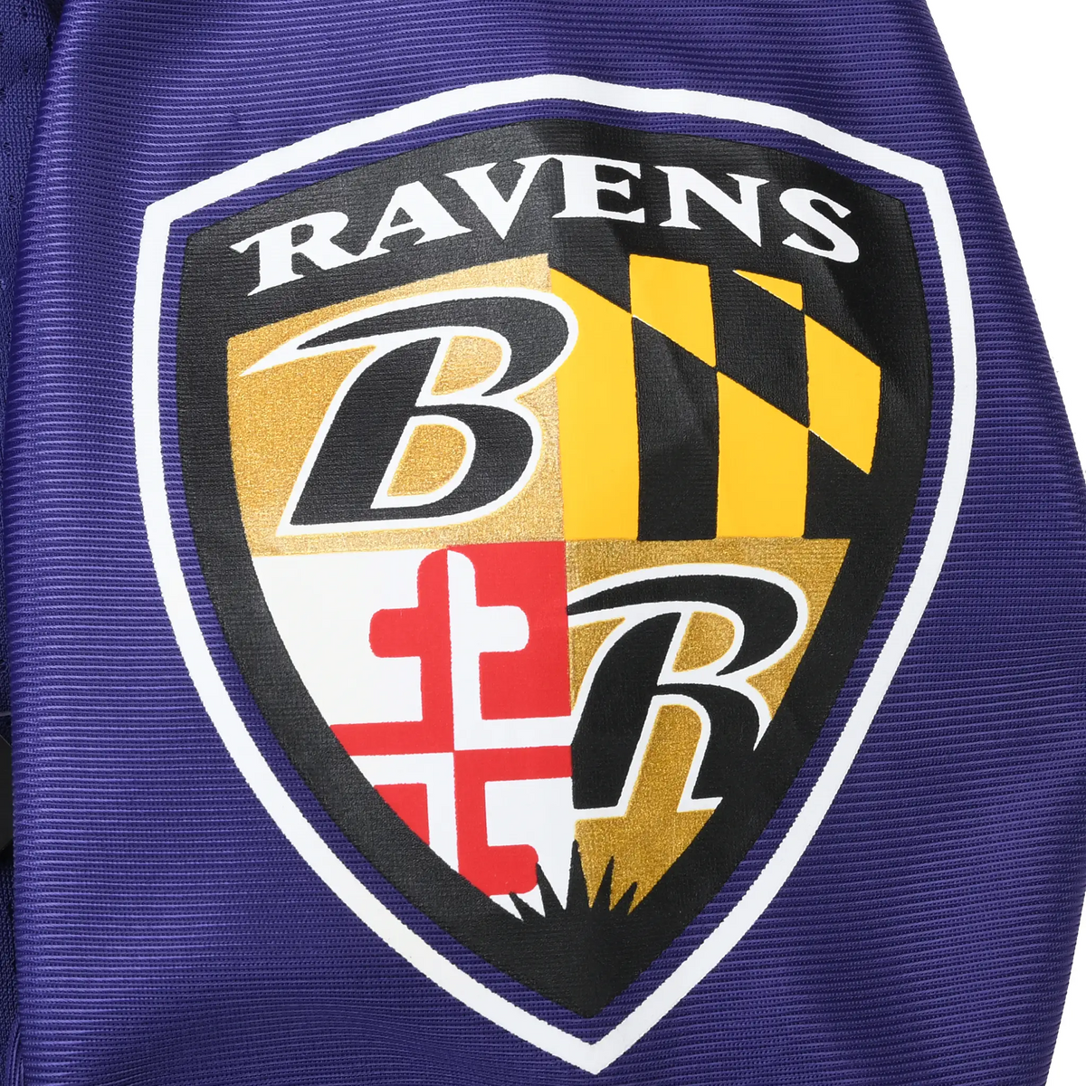 Close-up of Baltimore Ravens shield logo patch on purple sleeve