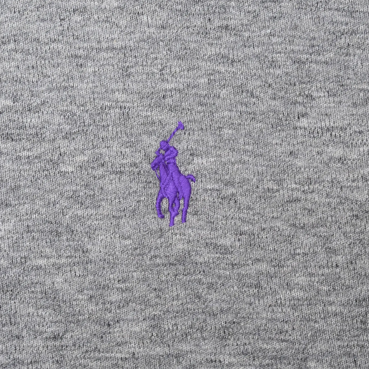 Close-up of purple Polo Ralph Lauren pony embroidery on grey fabric