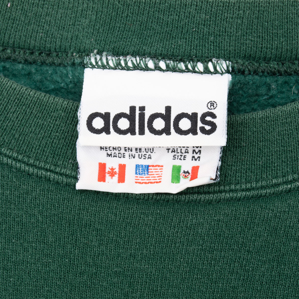 Adidas neck label showing size medium and Made in USA text