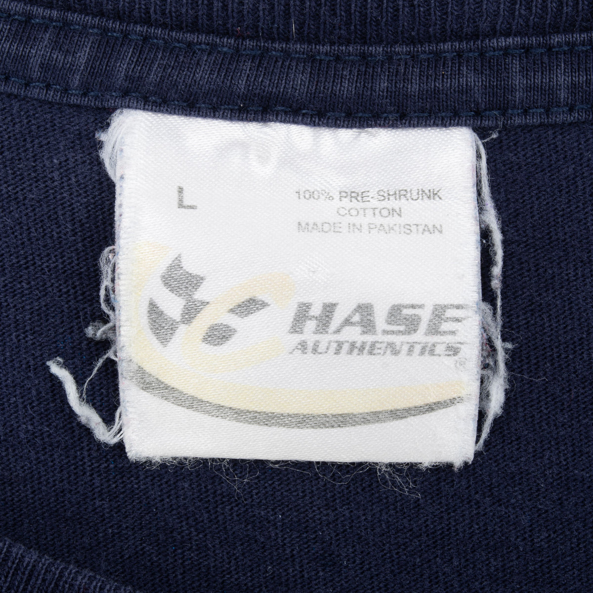 Close-up of Chase Authentics size L neck tag on navy Jimmie Johnson tee