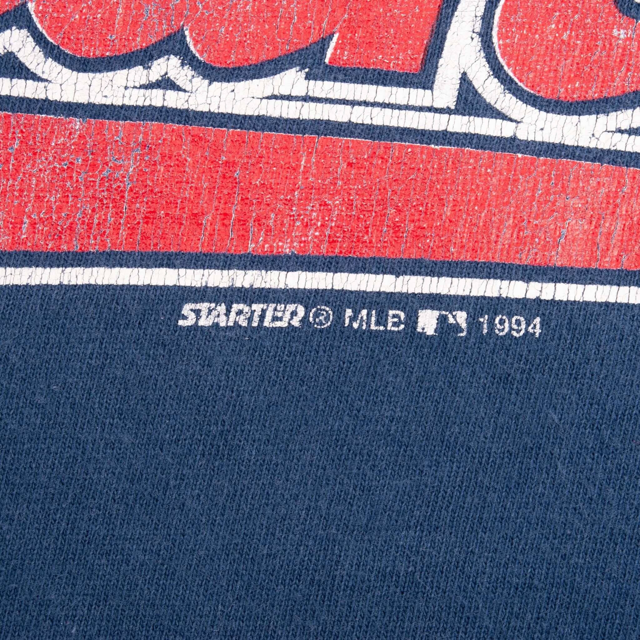 Close-up of Starter MLB 1994 copyright text beneath the distressed chest print
