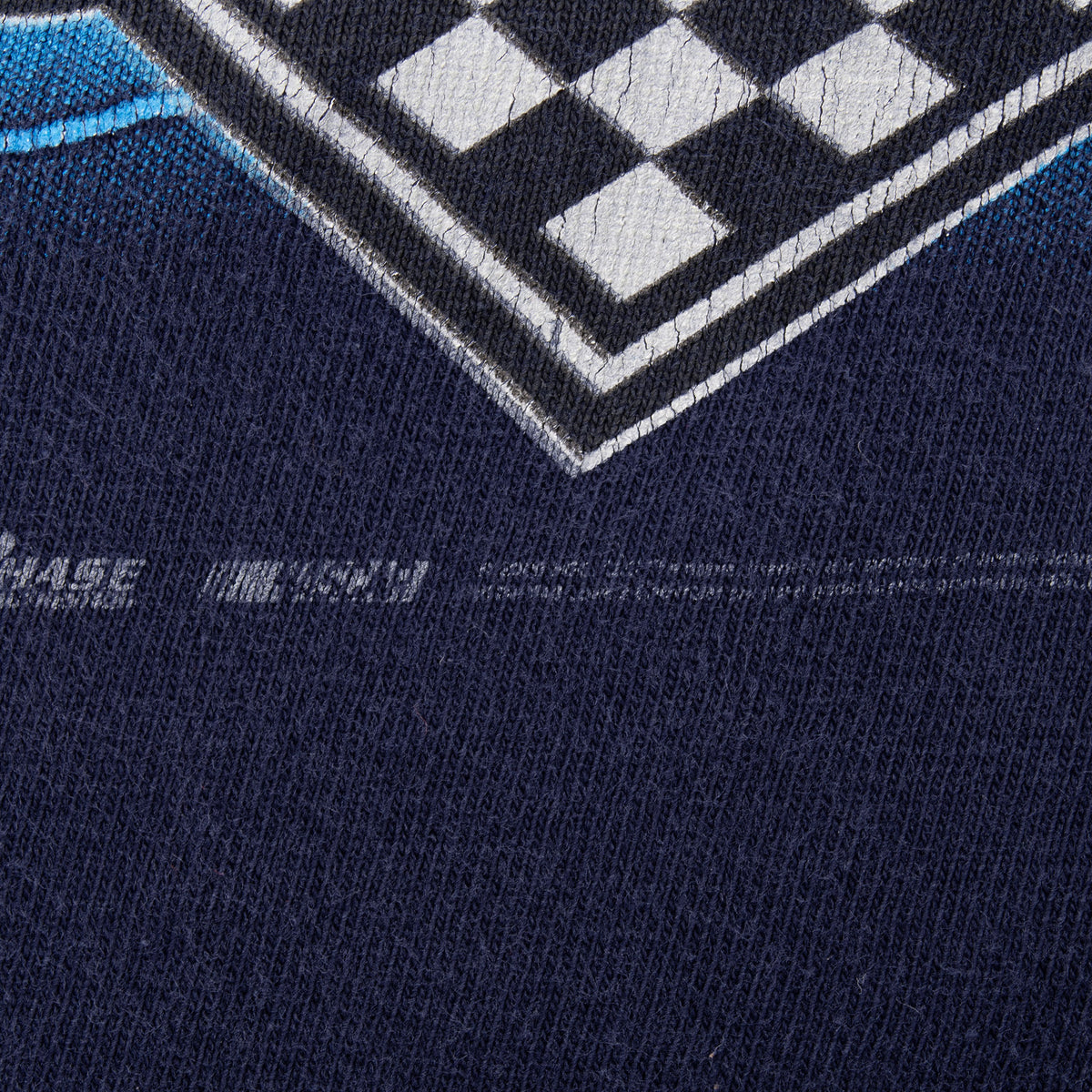 Close-up of navy fabric and checkered graphic showing faint printed copyright text
