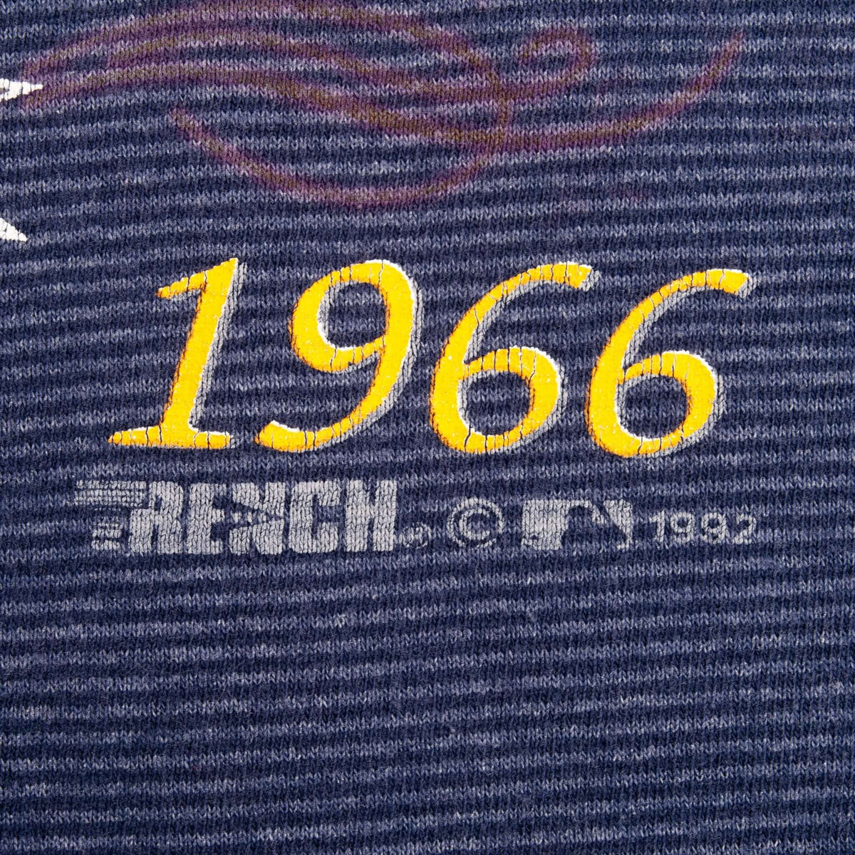 Close-up of yellow 1966 lettering and gray MLB 1992 copyright mark on chest print