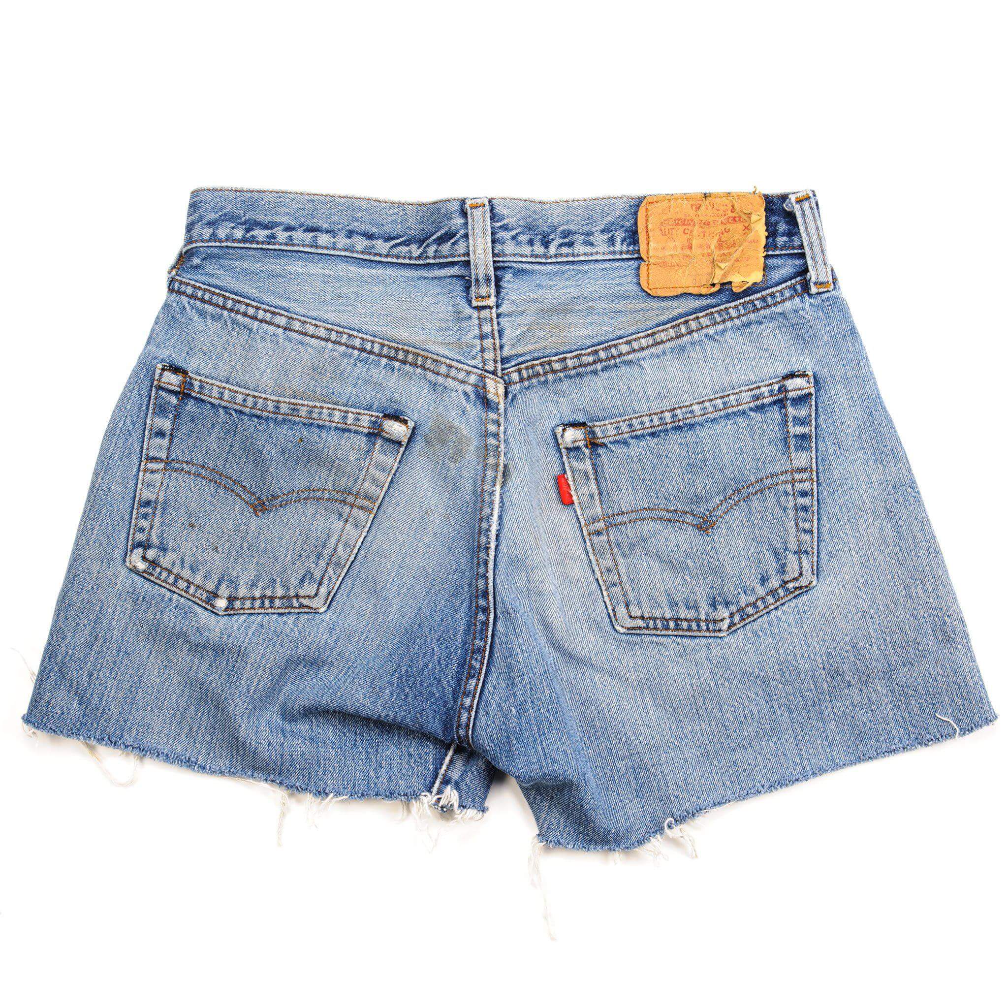Back of blue Levi's 501 denim shorts with arcuate pocket stitching and waistband patch
