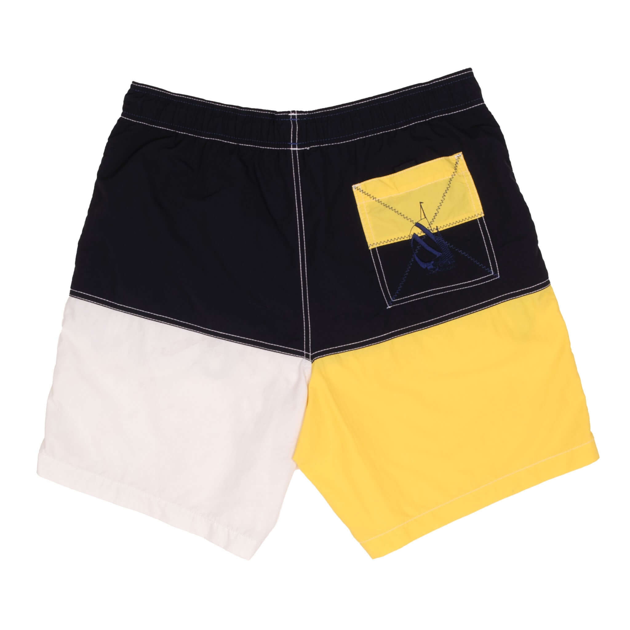 Back of Nautica swim trunks in navy, white and yellow with color-block patch pocket