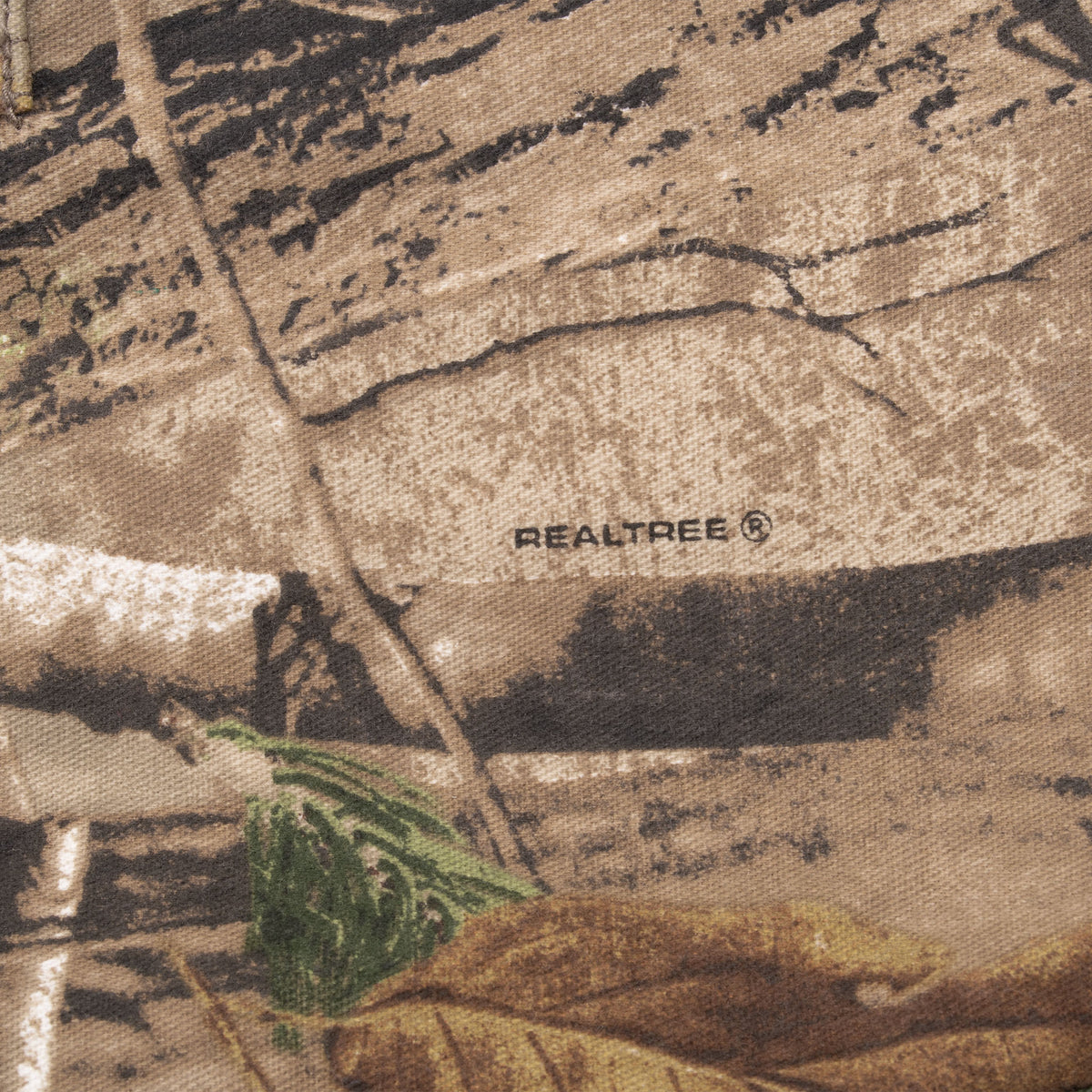 Close-up of Realtree logo printed on brown woodland camouflage fabric