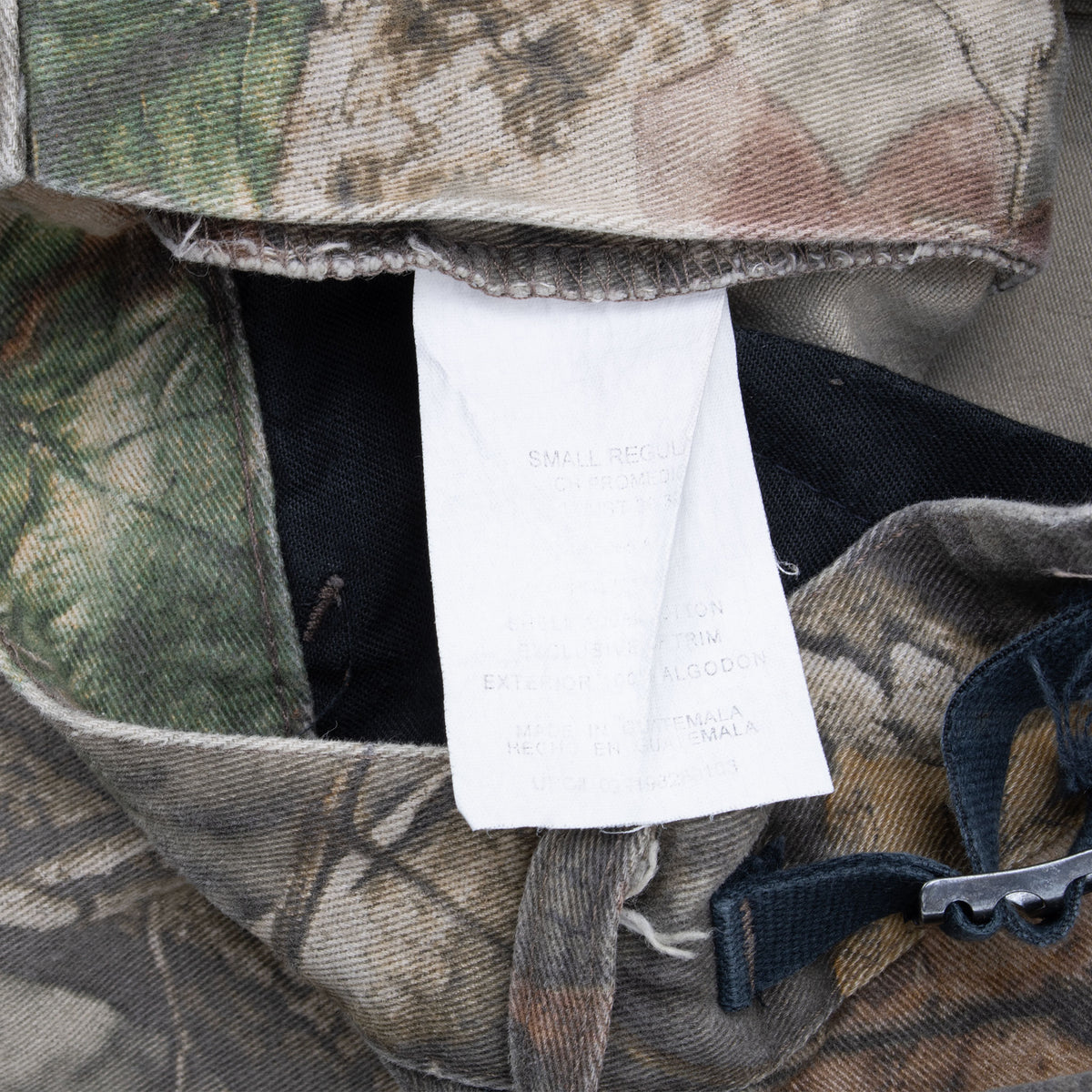 Interior size and care tag on Walls camouflage cargo pants marked Small Regular