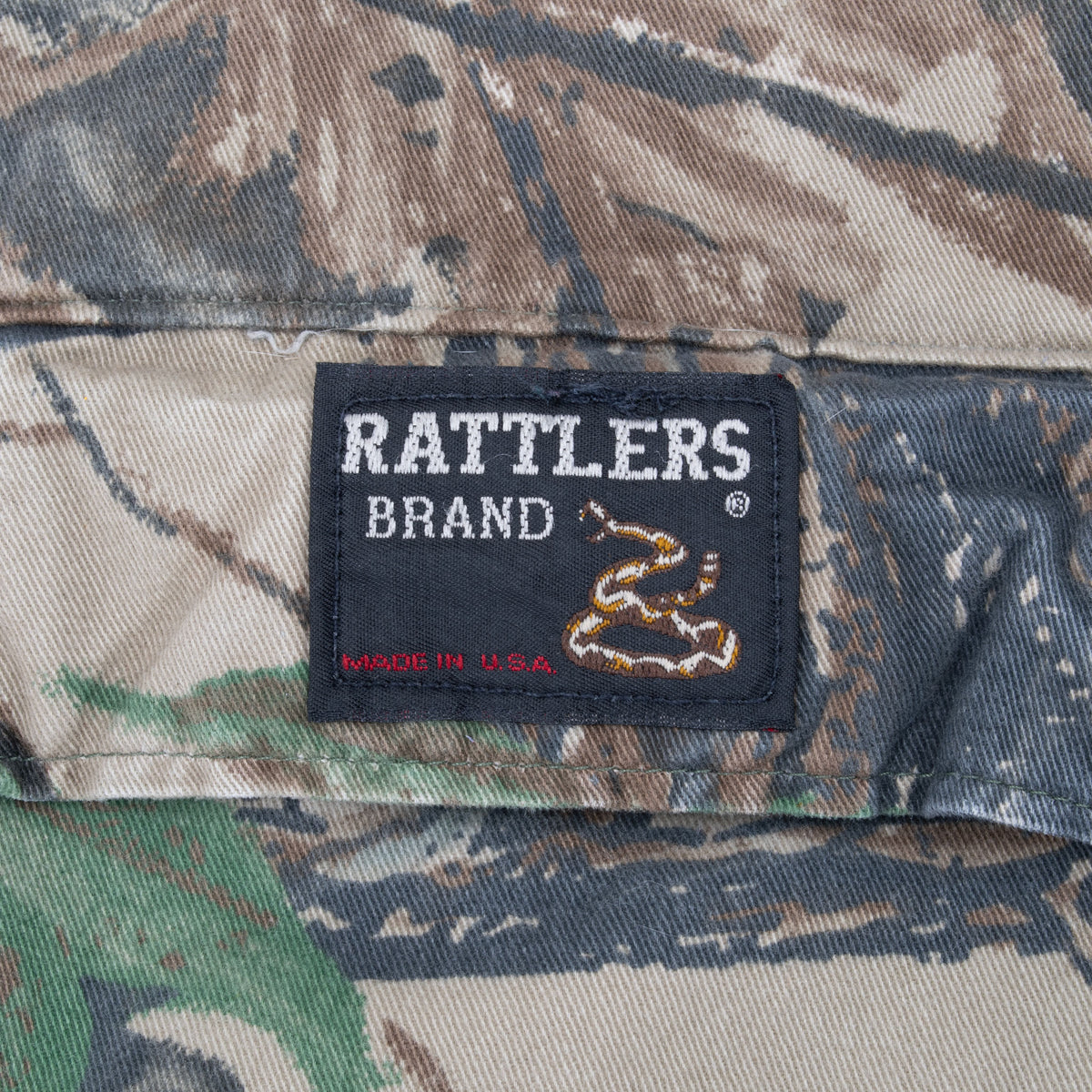 Rattlers Brand snake logo label on Realtree camouflage fabric