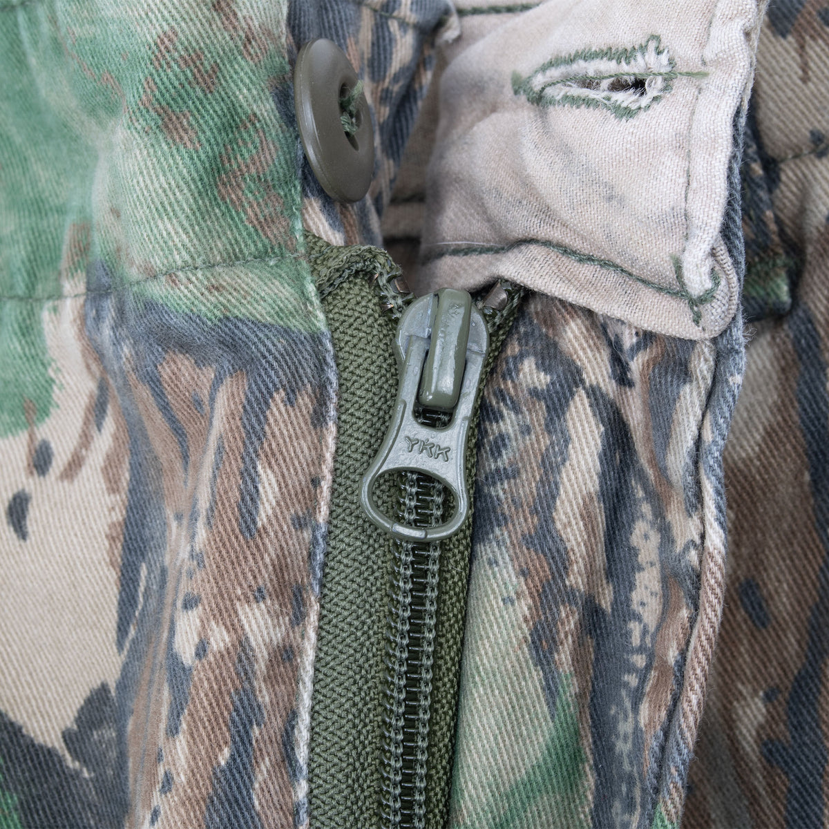 Close-up of button and YKK zipper fly on Realtree camouflage pants