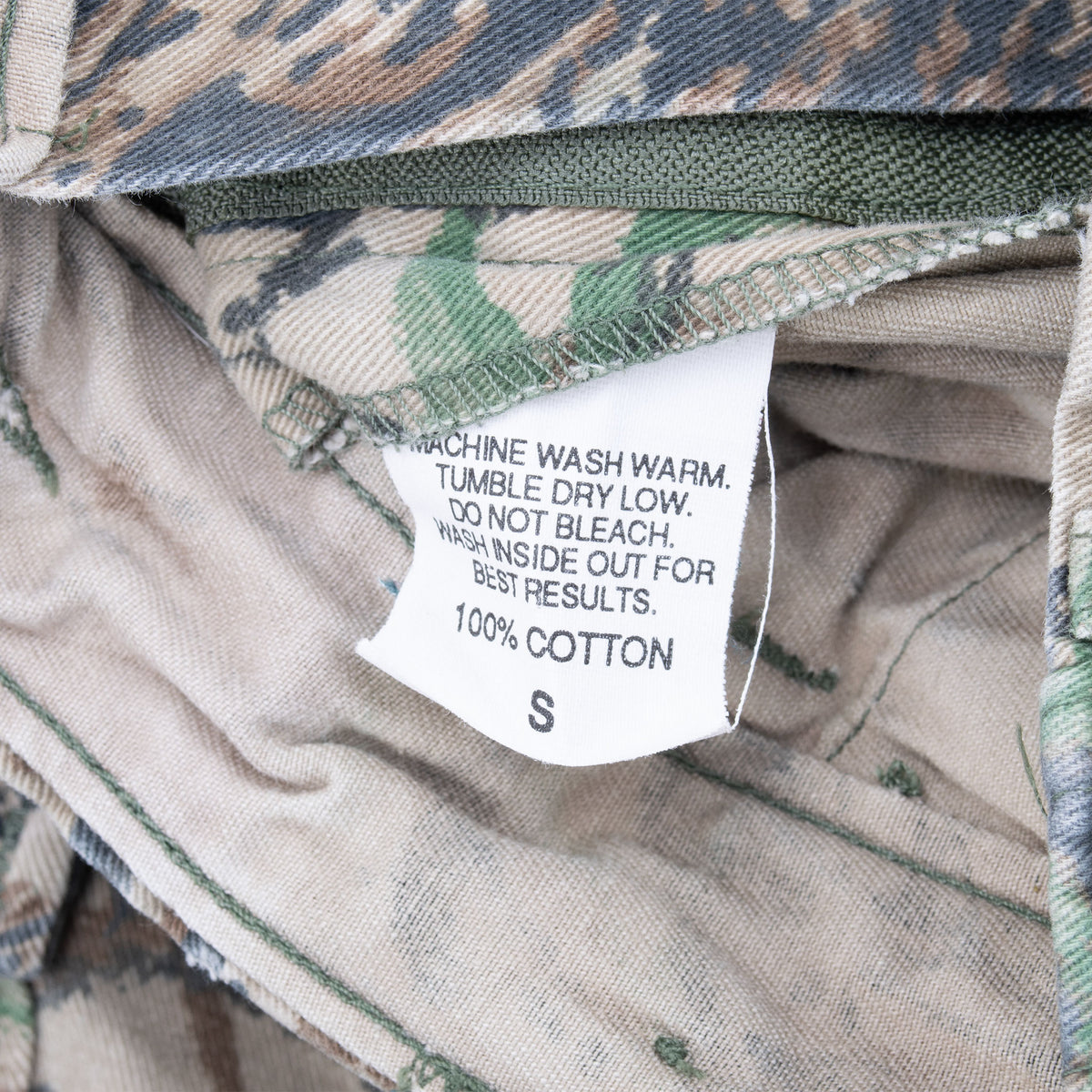 Interior care tag marked size S and 100% cotton on camouflage pants