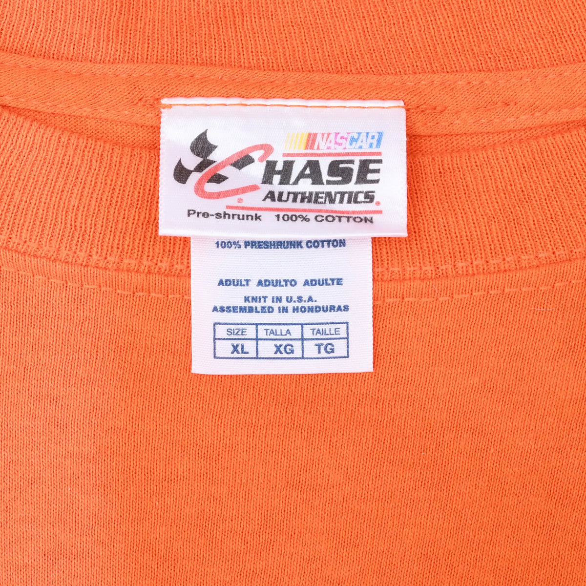 Close-up of NASCAR Chase Authentics neck label marked XL on orange fabric