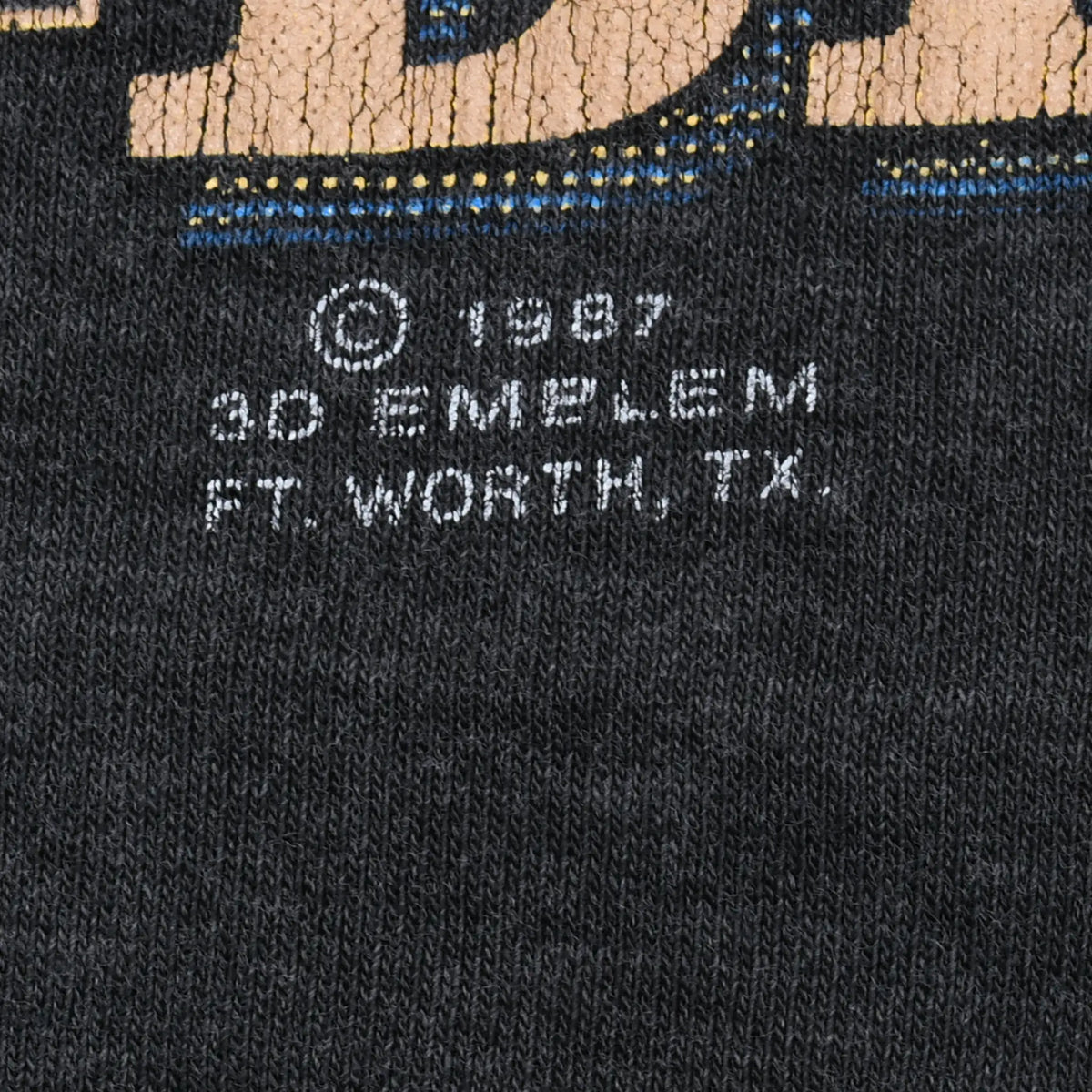 Close-up of 1987 3D Emblem Fort Worth, Texas copyright imprint on black fabric