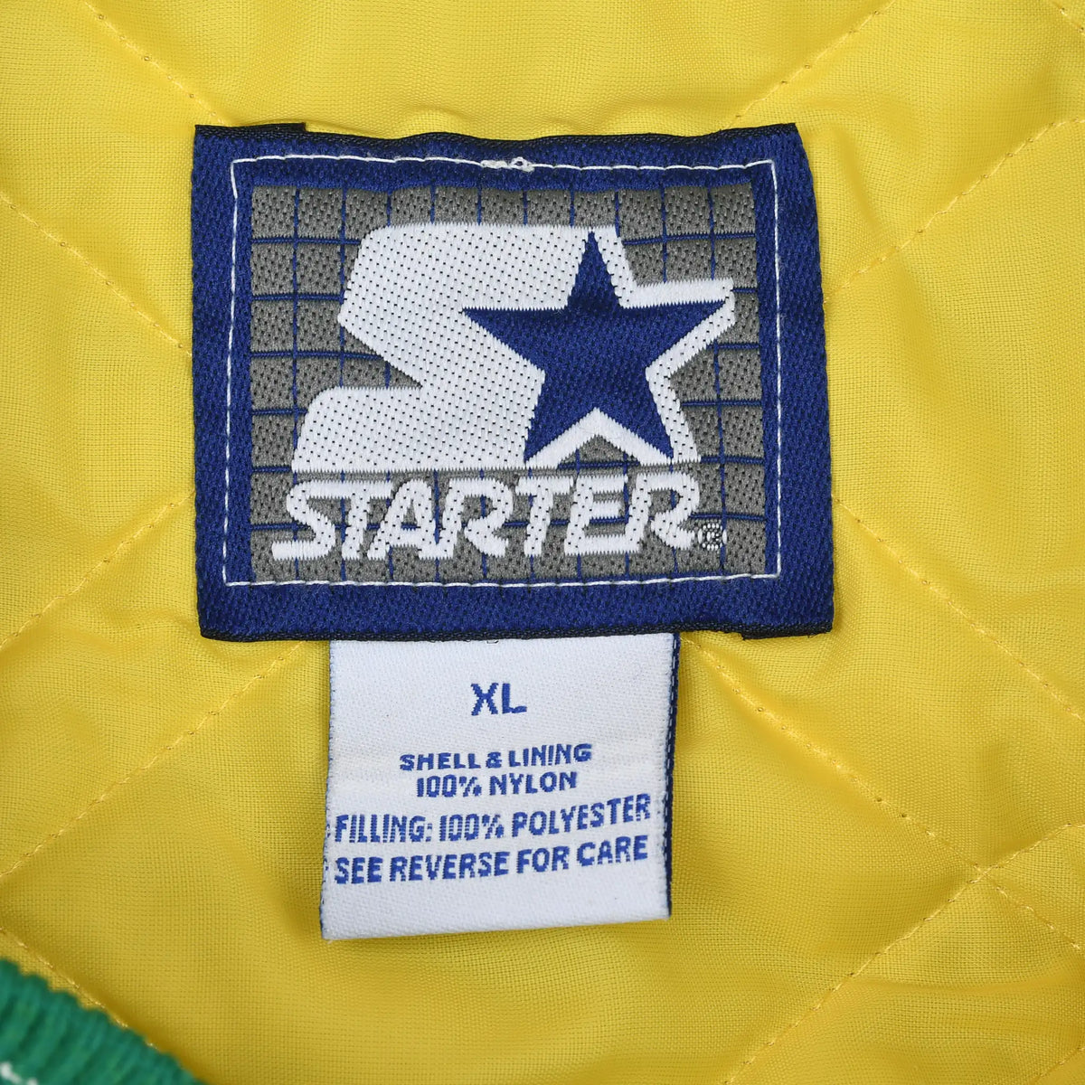 Starter brand label and XL care tag on yellow quilted jacket lining