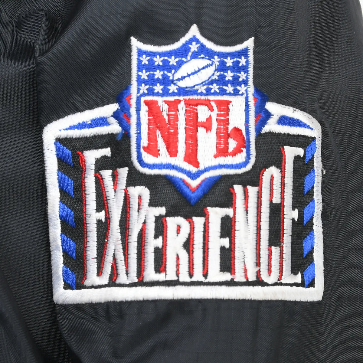 Close-up of embroidered NFL Experience patch on black jacket sleeve