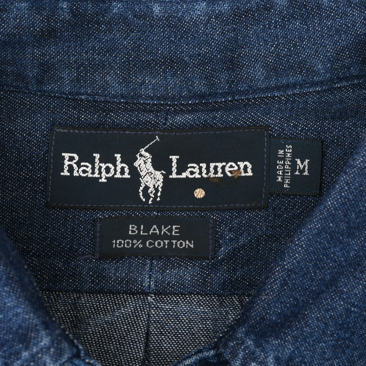 Close-up of Ralph Lauren Blake 100% cotton collar label and medium size tag inside denim shirt