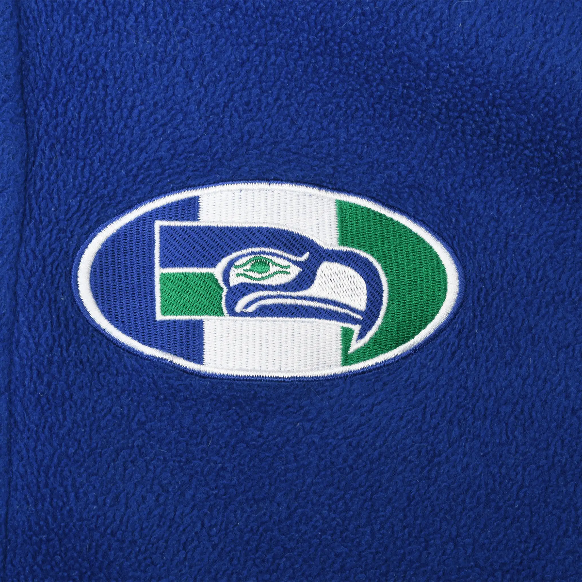 Close-up of embroidered Seattle Seahawks oval logo on blue fleece