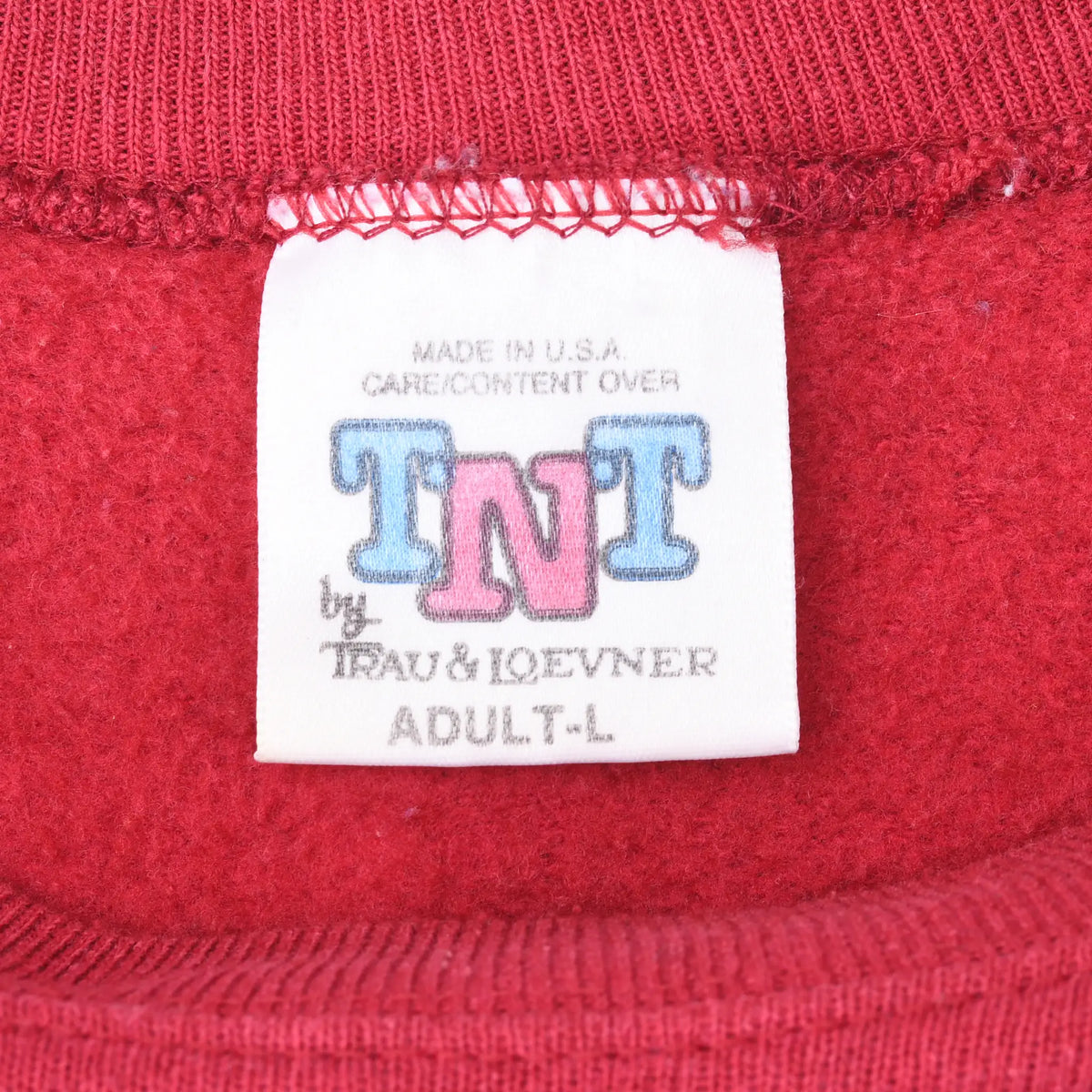 TNT by Trau & Loevner adult neck label on red sweatshirt, marked Made in USA