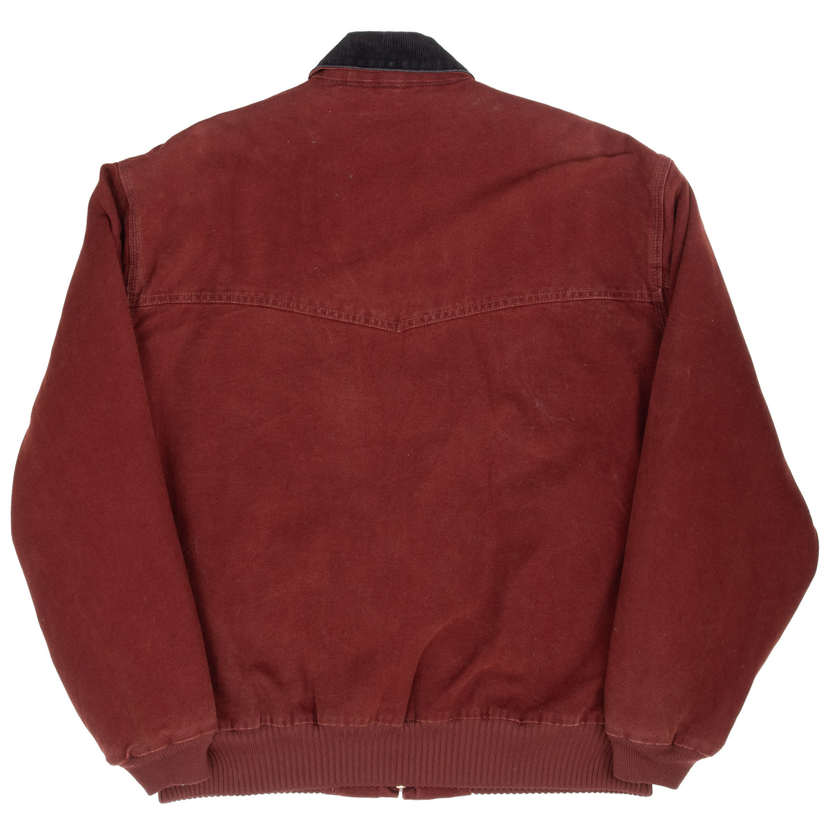 Back of clay red Carhartt Santa Fe jacket showing pointed Western yoke seam and ribbed hem
