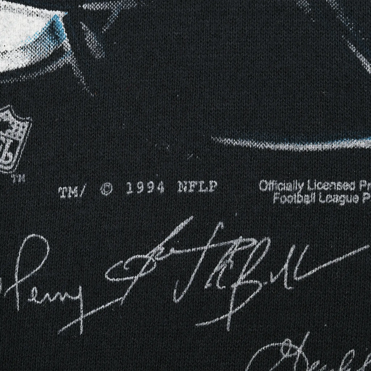 Close-up of 1994 NFL licensing text and printed player signatures
