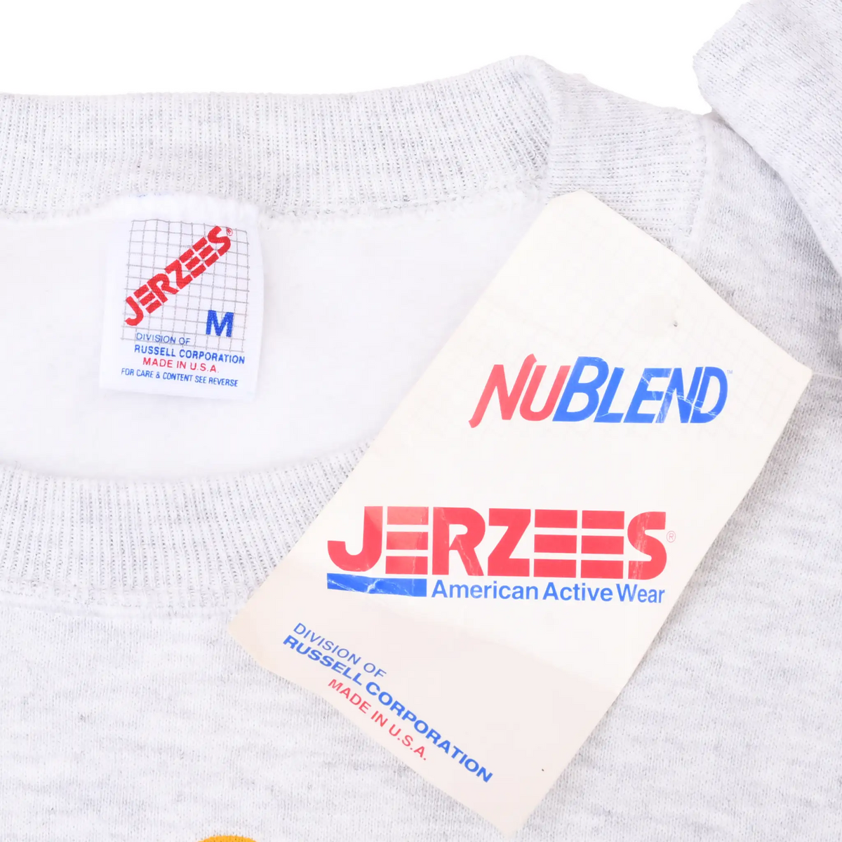 Jerzees medium neck label and NuBlend hang tag on gray sweatshirt