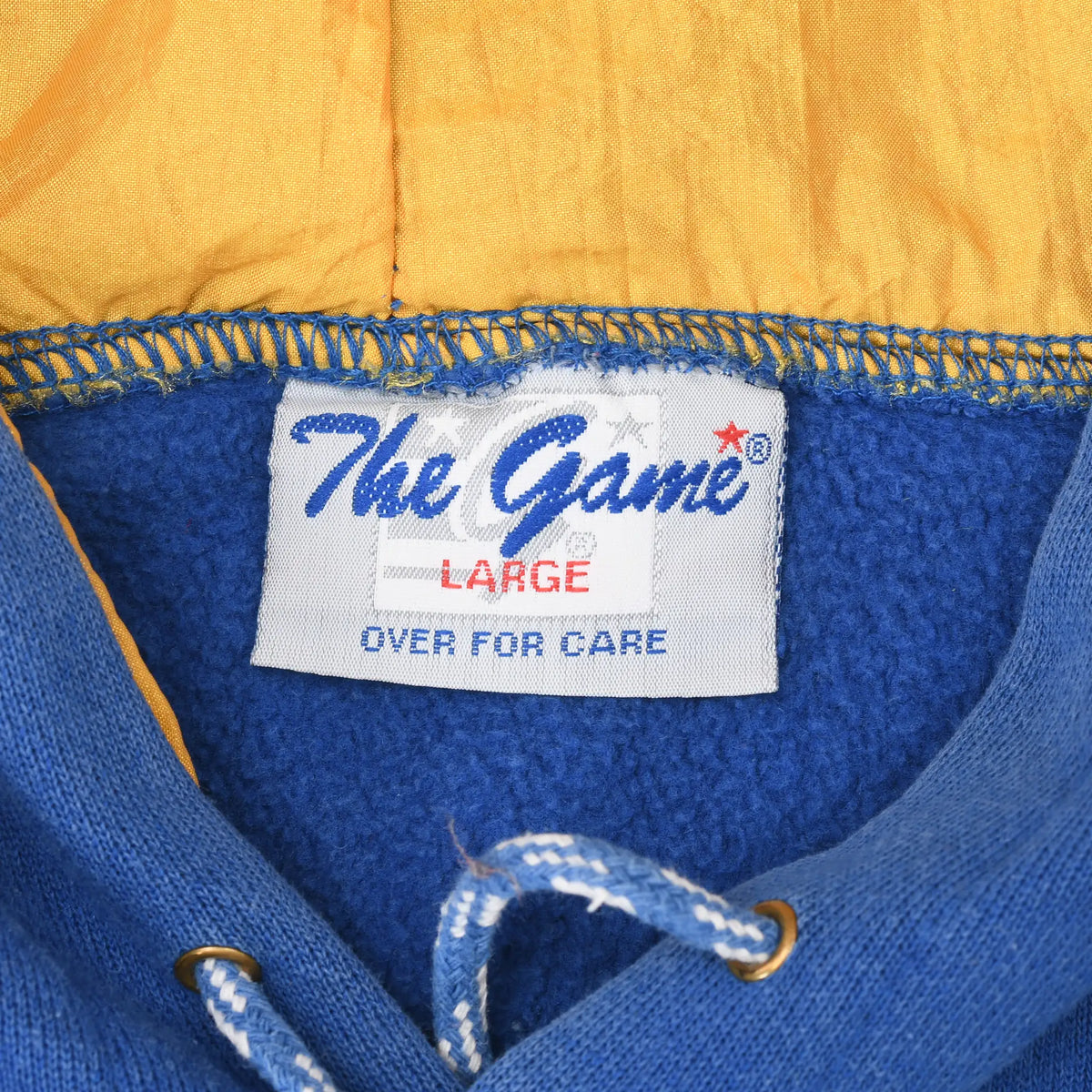 Close-up of The Game size Large neck label inside the blue and gold hoodie