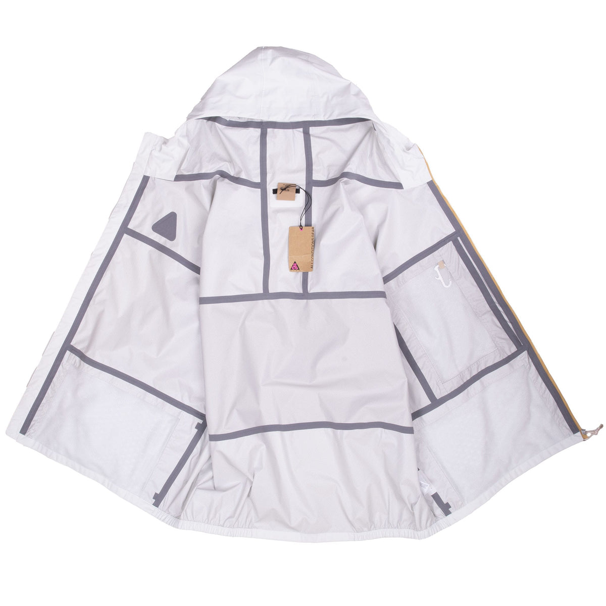 Open Nike ACG windbreaker showing gray mesh-patterned interior and hanging tag