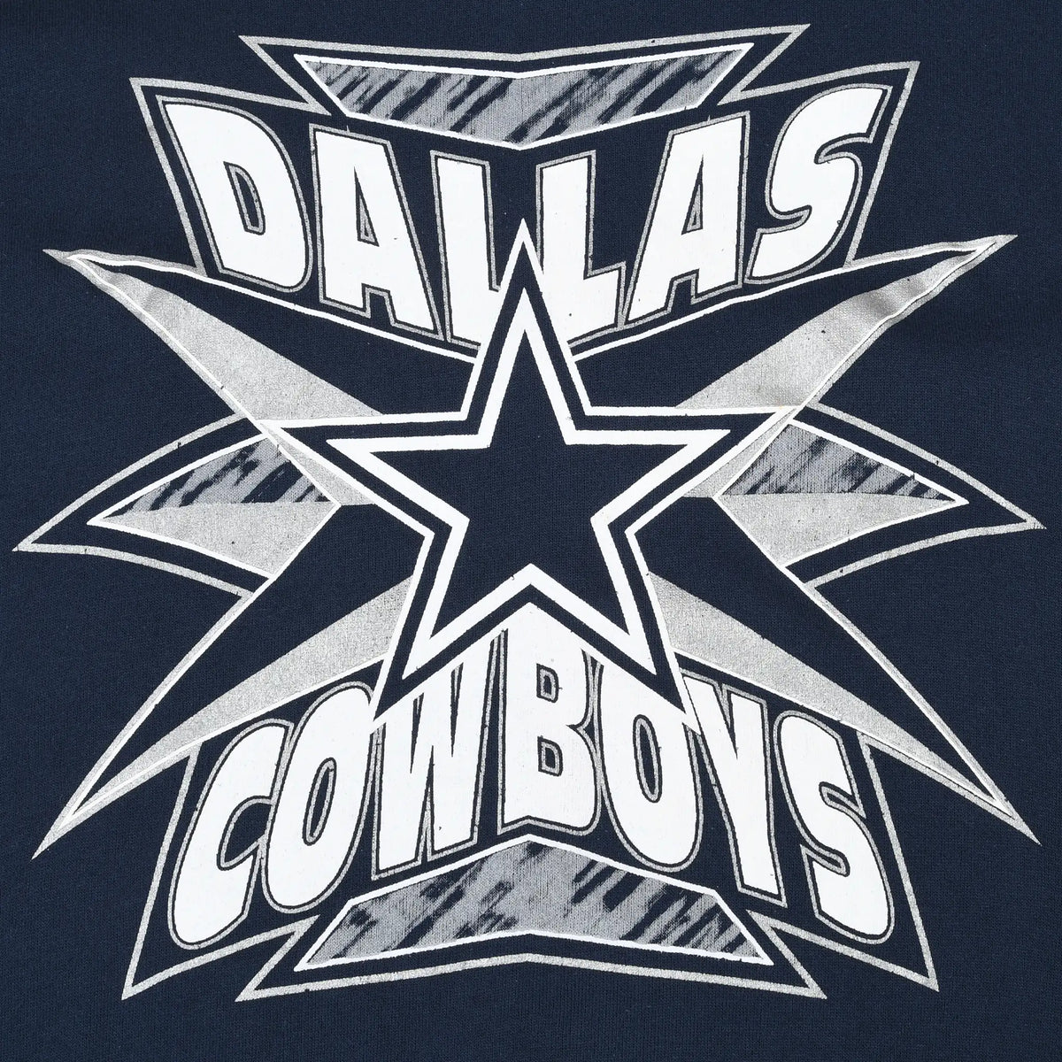 Close-up of white and gray Dallas Cowboys star print on navy fabric
