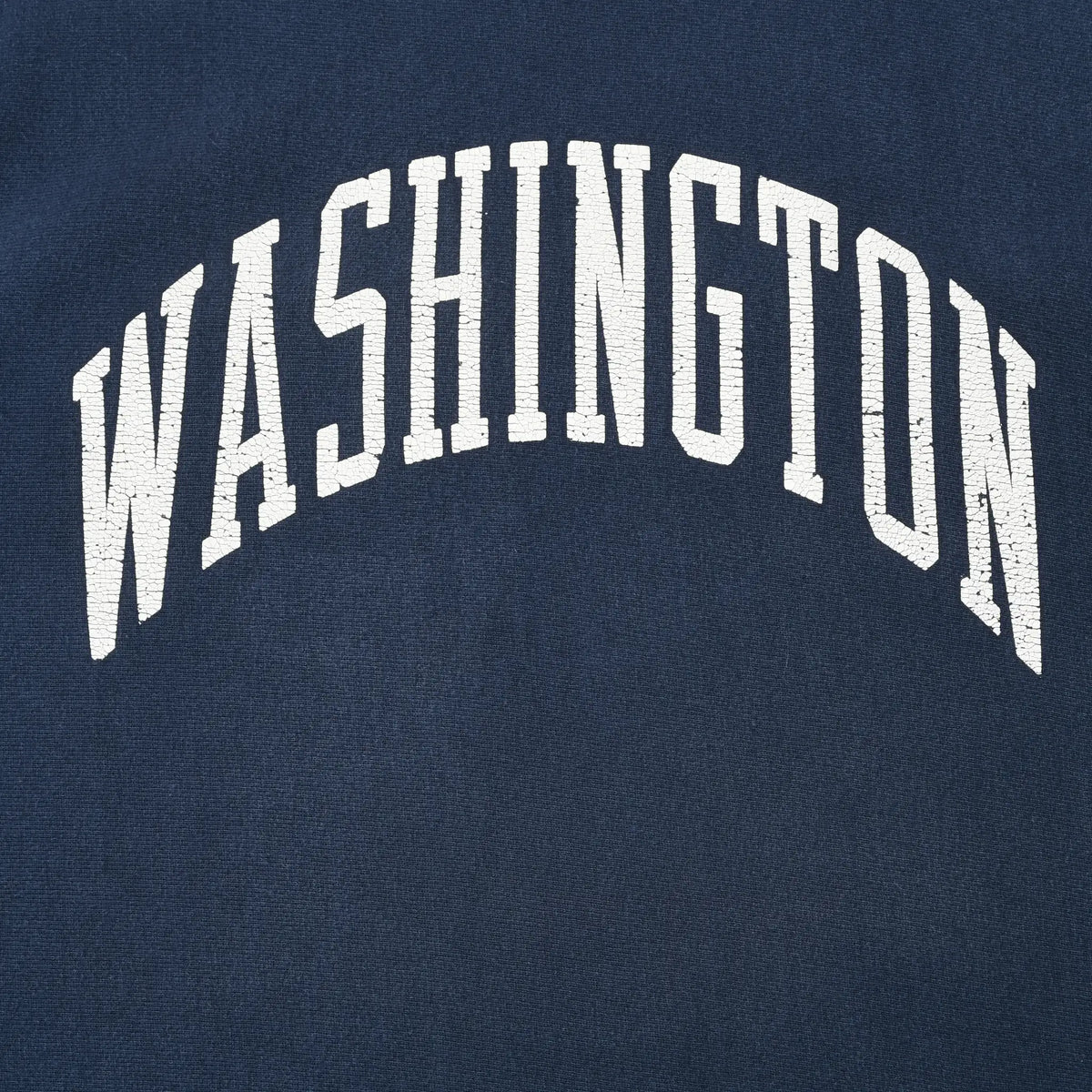 Close-up of arched white Washington print on navy sweatshirt fabric