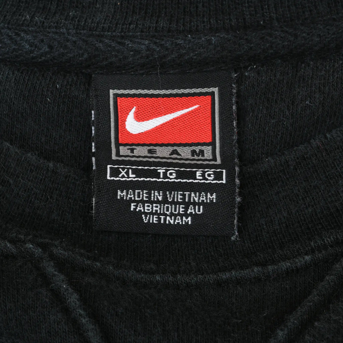 Close-up of Nike Team XL neck label inside black Missouri sweatshirt