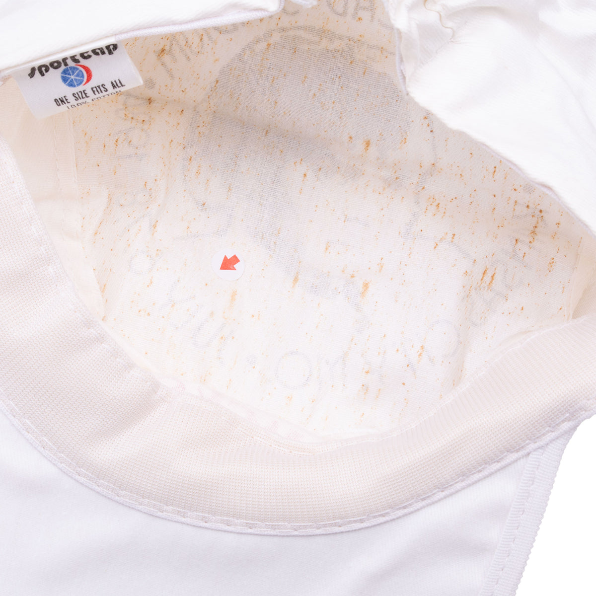 Interior of white Jacksons Victory Tour cap showing lining, label, and discoloration