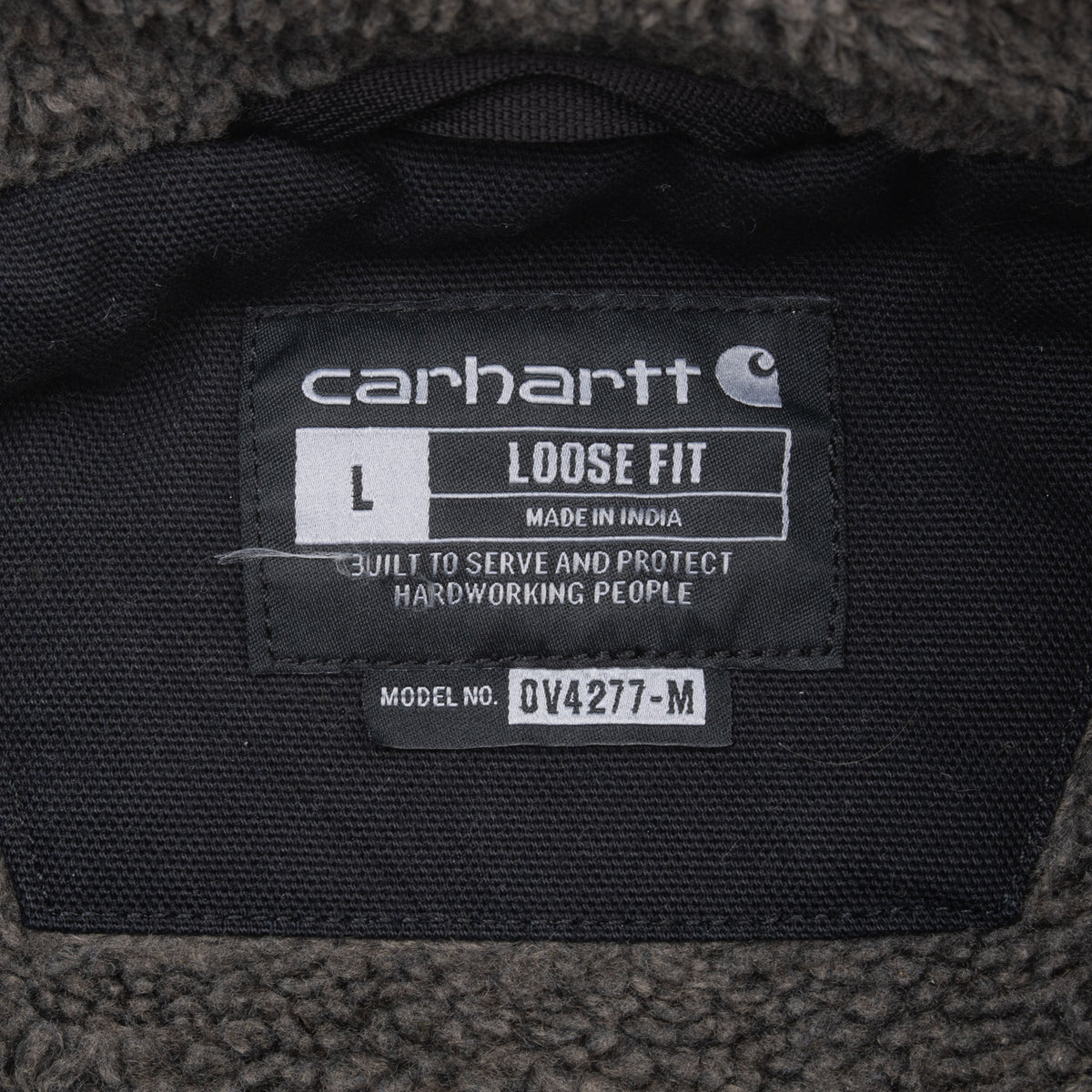 Carhartt neck label showing size large, loose fit and model V42-77-M