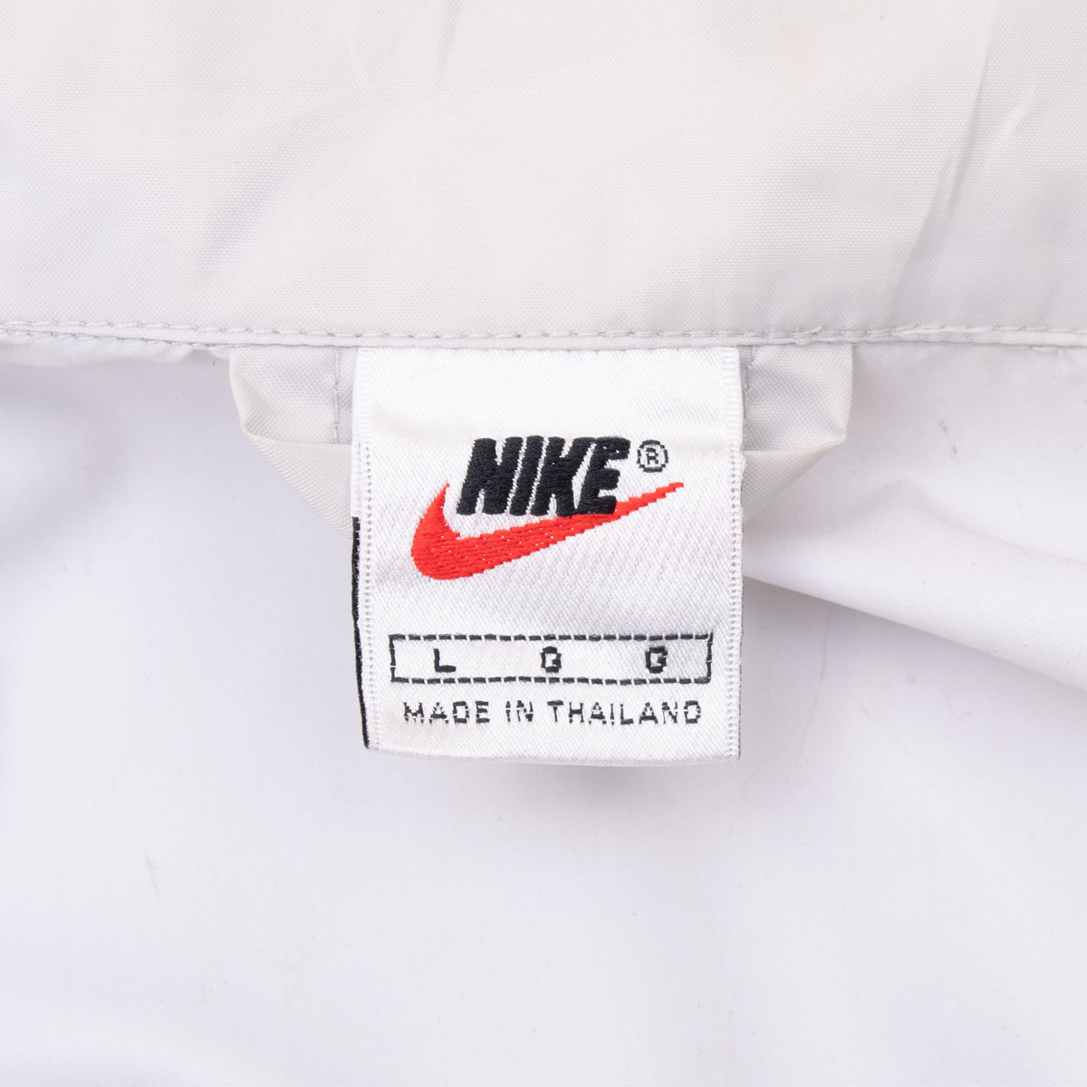 Nike neck label showing size large on white windbreaker