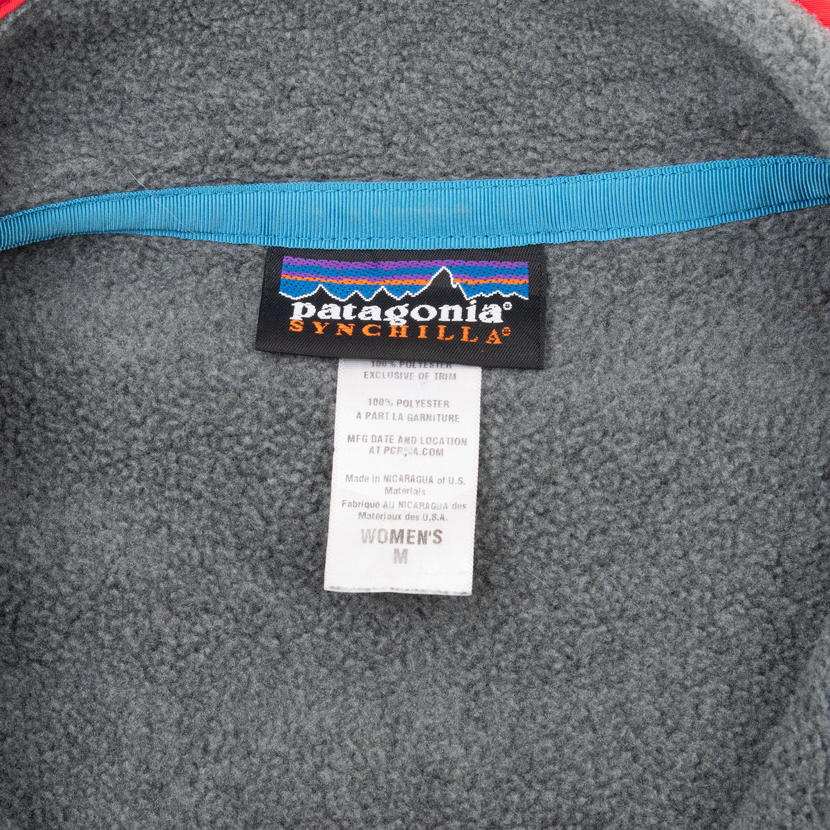 Patagonia Synchilla neck and women's medium size labels inside grey fleece jacket
