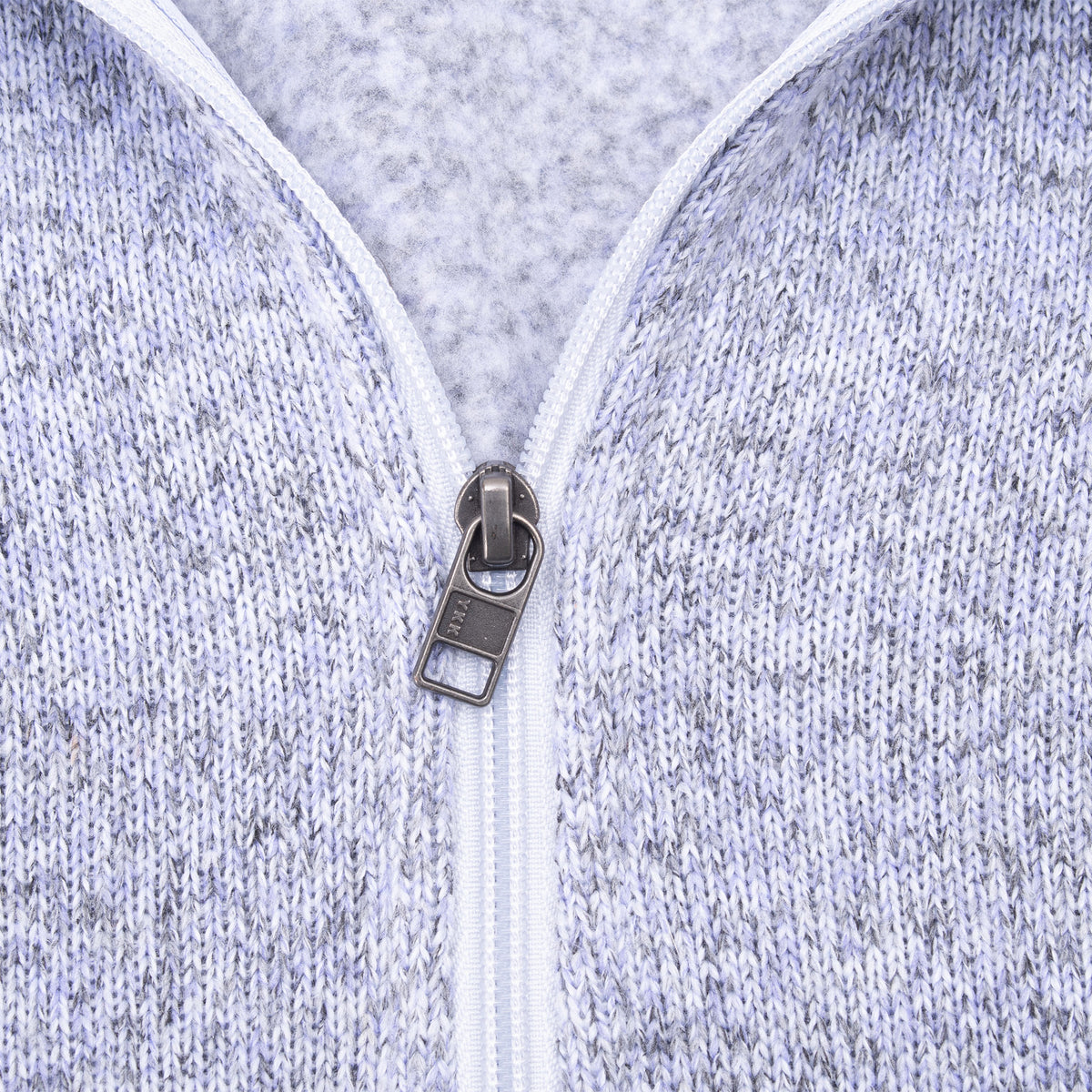 Close-up of quarter-zip pull and knit texture on light purple Patagonia fleece