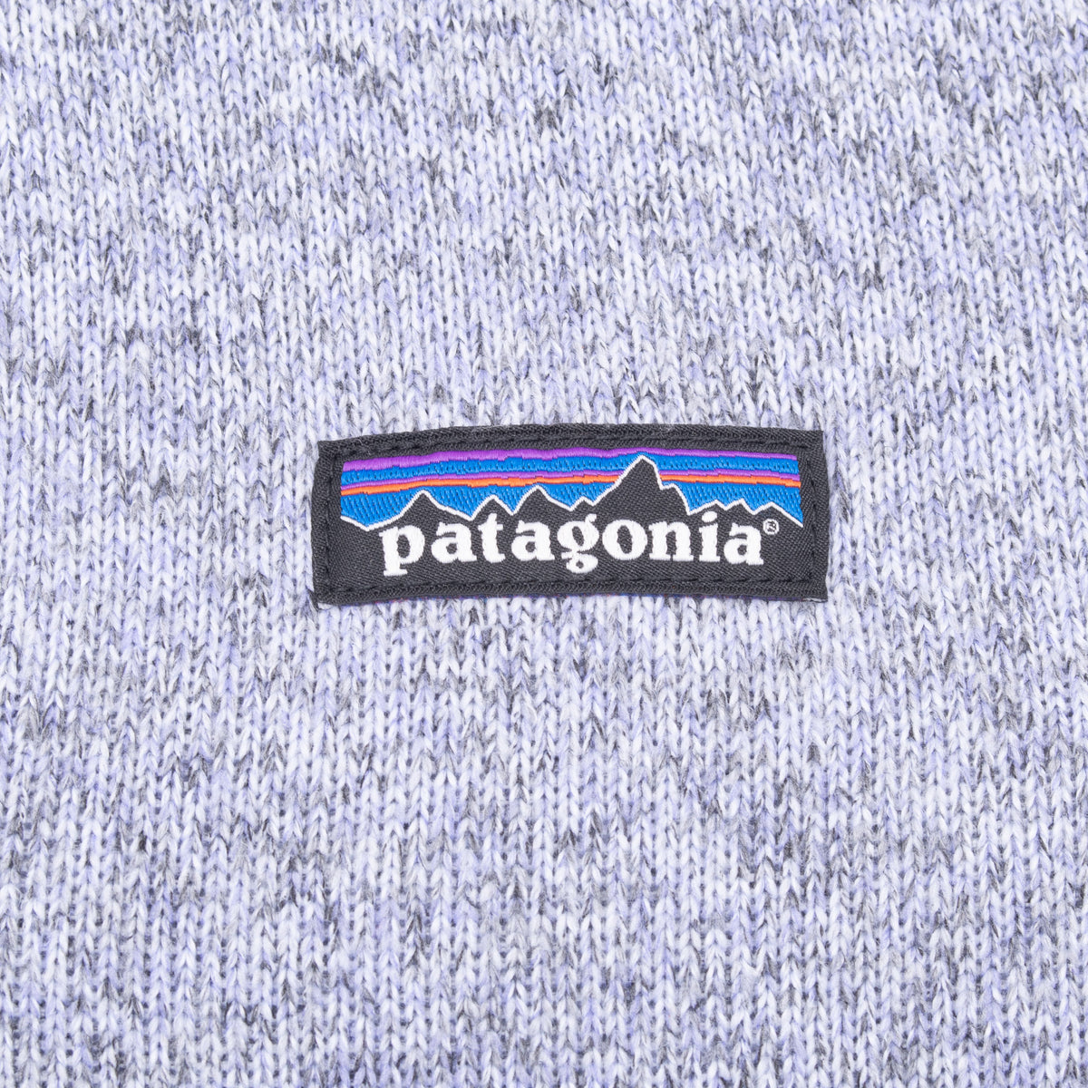 Close-up of Patagonia chest logo patch on light purple knit fleece
