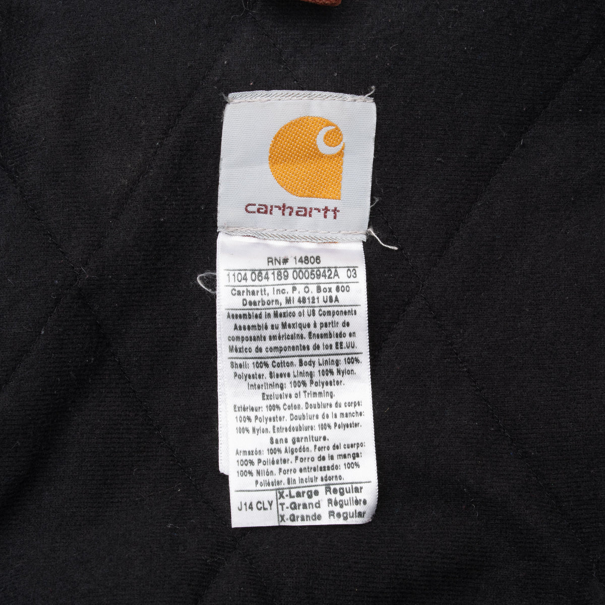 Carhartt jacket interior label showing style J14 CLY and size XL