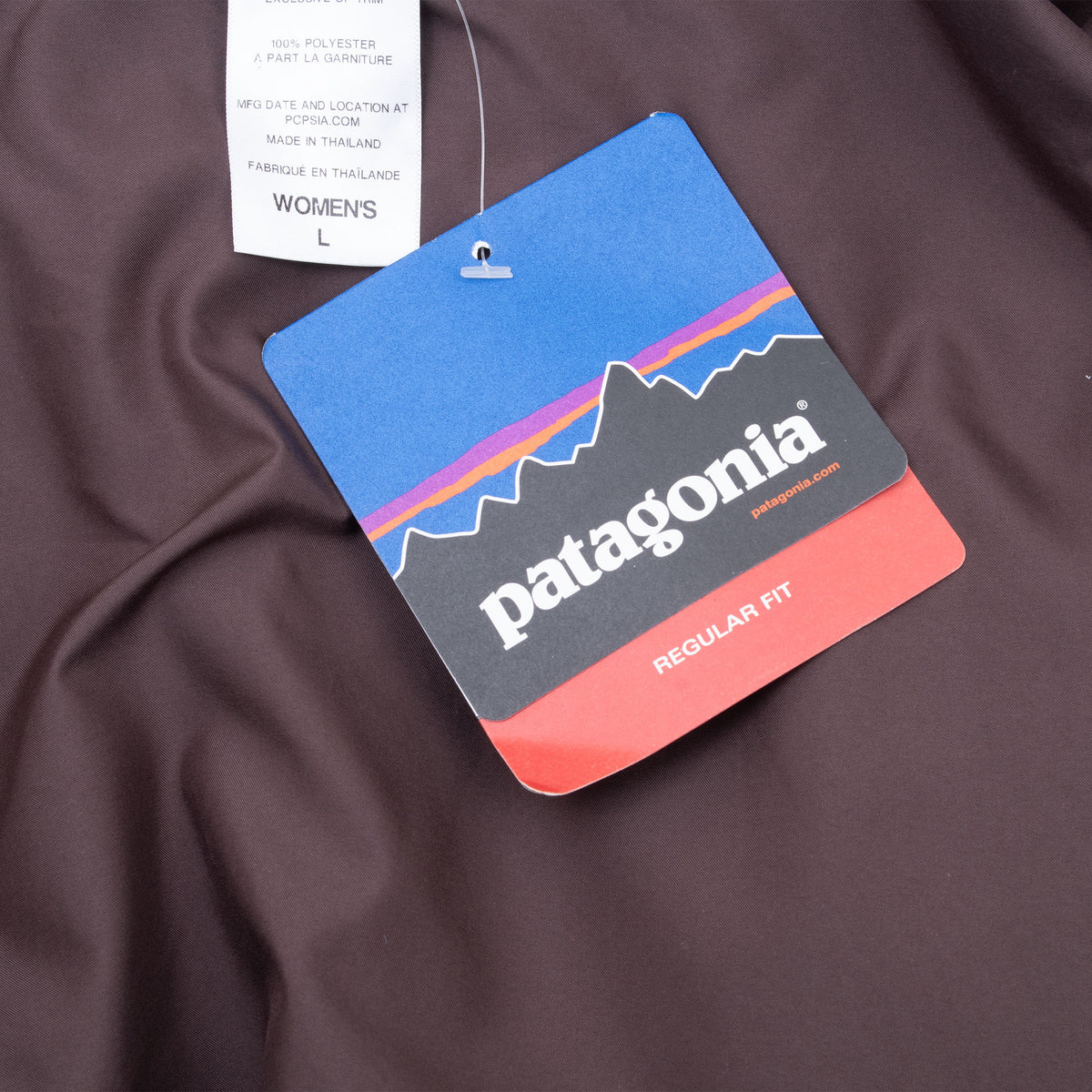 Patagonia regular fit hangtag attached inside the brown vest lining