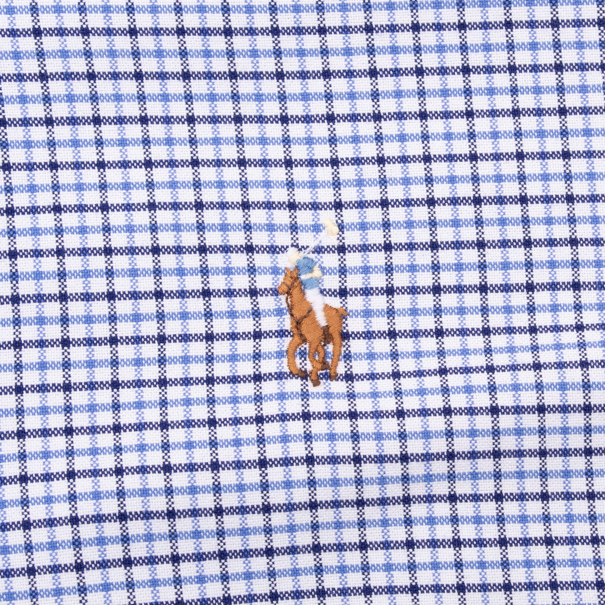 Multicolor embroidered Polo pony chest logo on blue and white plaid fabric