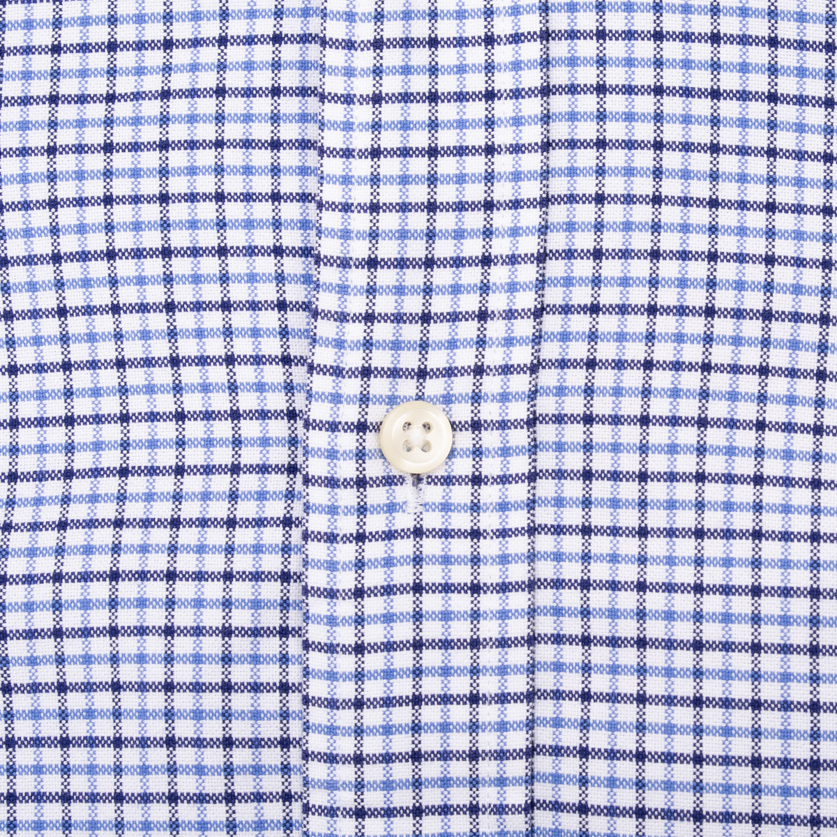 Close-up of white front button and blue plaid pattern on Ralph Lauren shirt
