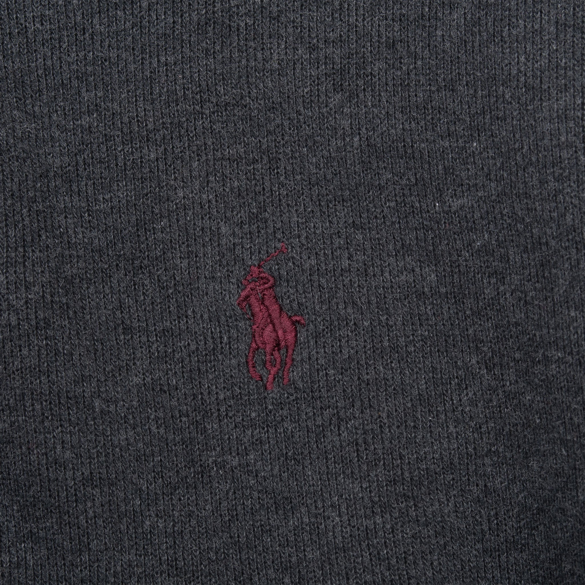 Close-up of red Polo pony embroidery on dark grey sweater