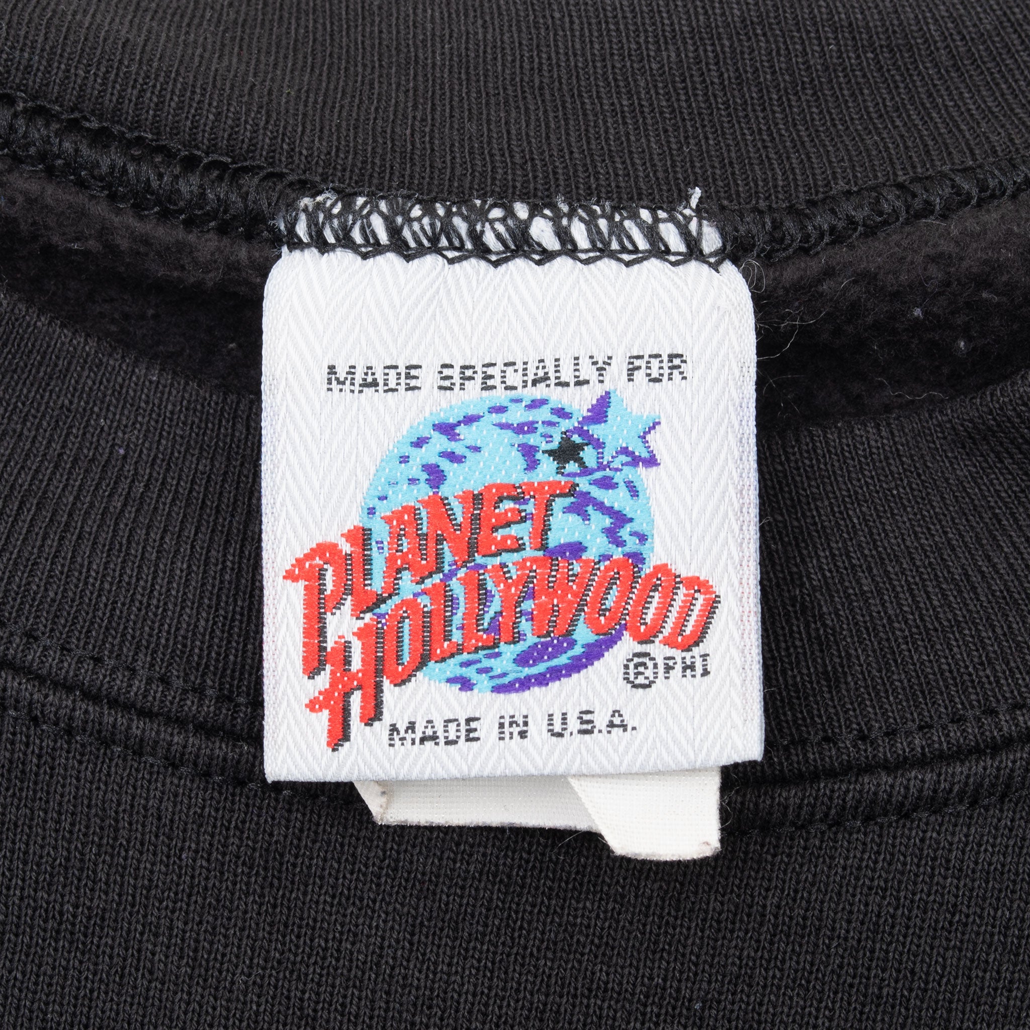 Planet Hollywood neck label on black sweatshirt stating Made in U.S.A.