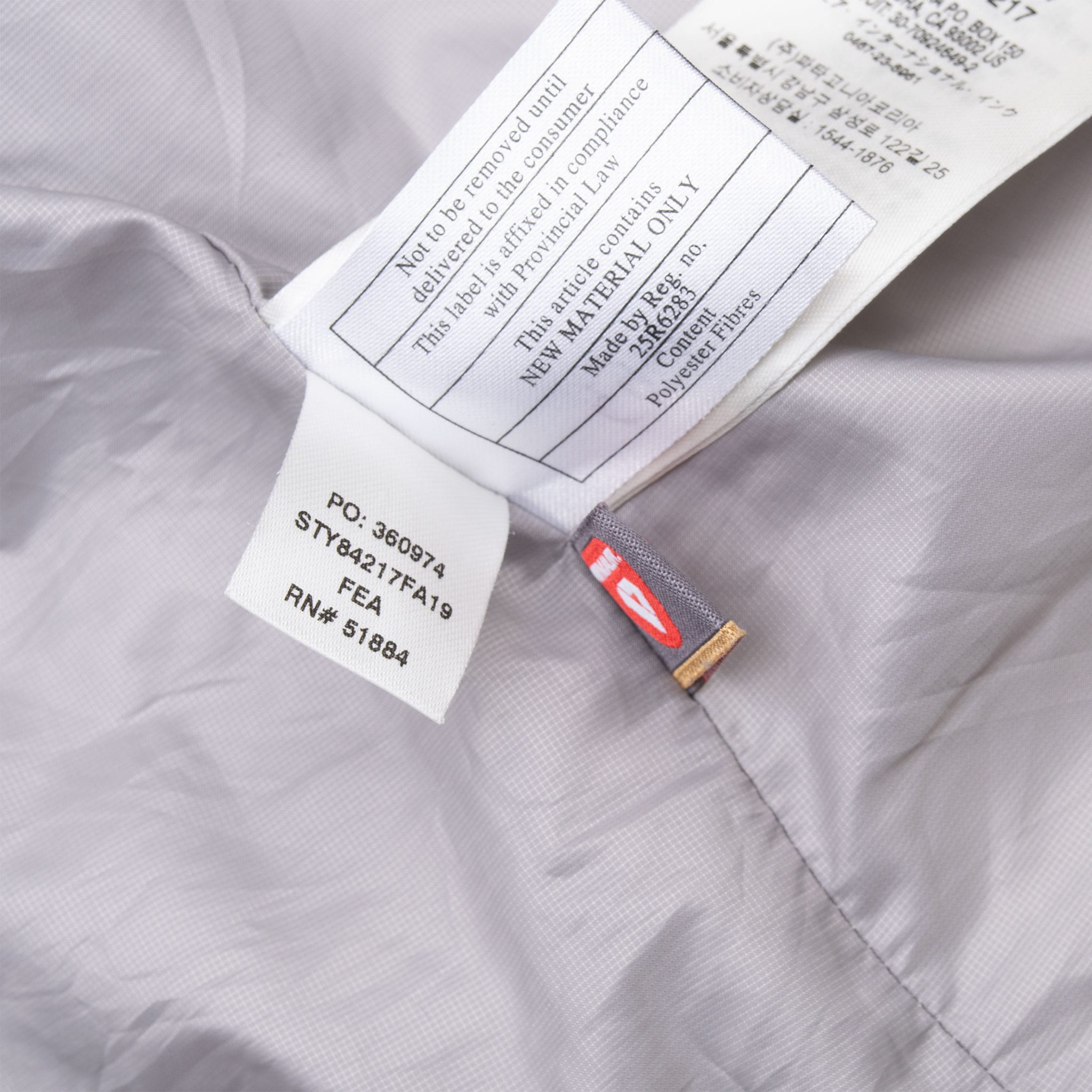 Interior care and style labels on Patagonia Nano Puff jacket, including STY84217