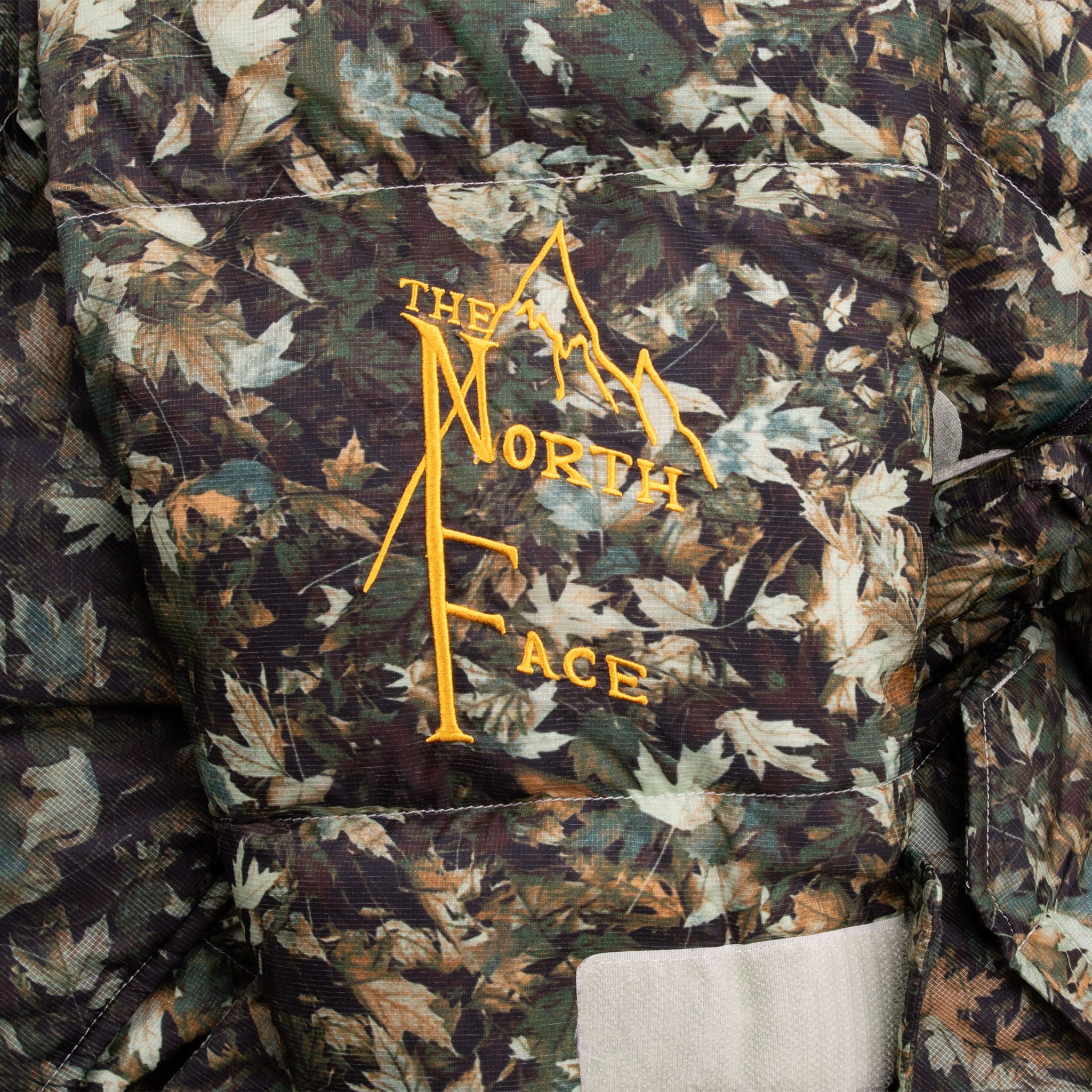 The Moment You See The Oversized Baffles You Know You're Looking At The Iconic Nuptse Jacket. This Durable Piece Has Lofty 600-Fill Down And A Sleek, Stowable Hood. Vintage The North Face 600 Nuptse Camo Leaf Down Jacket Size Medium