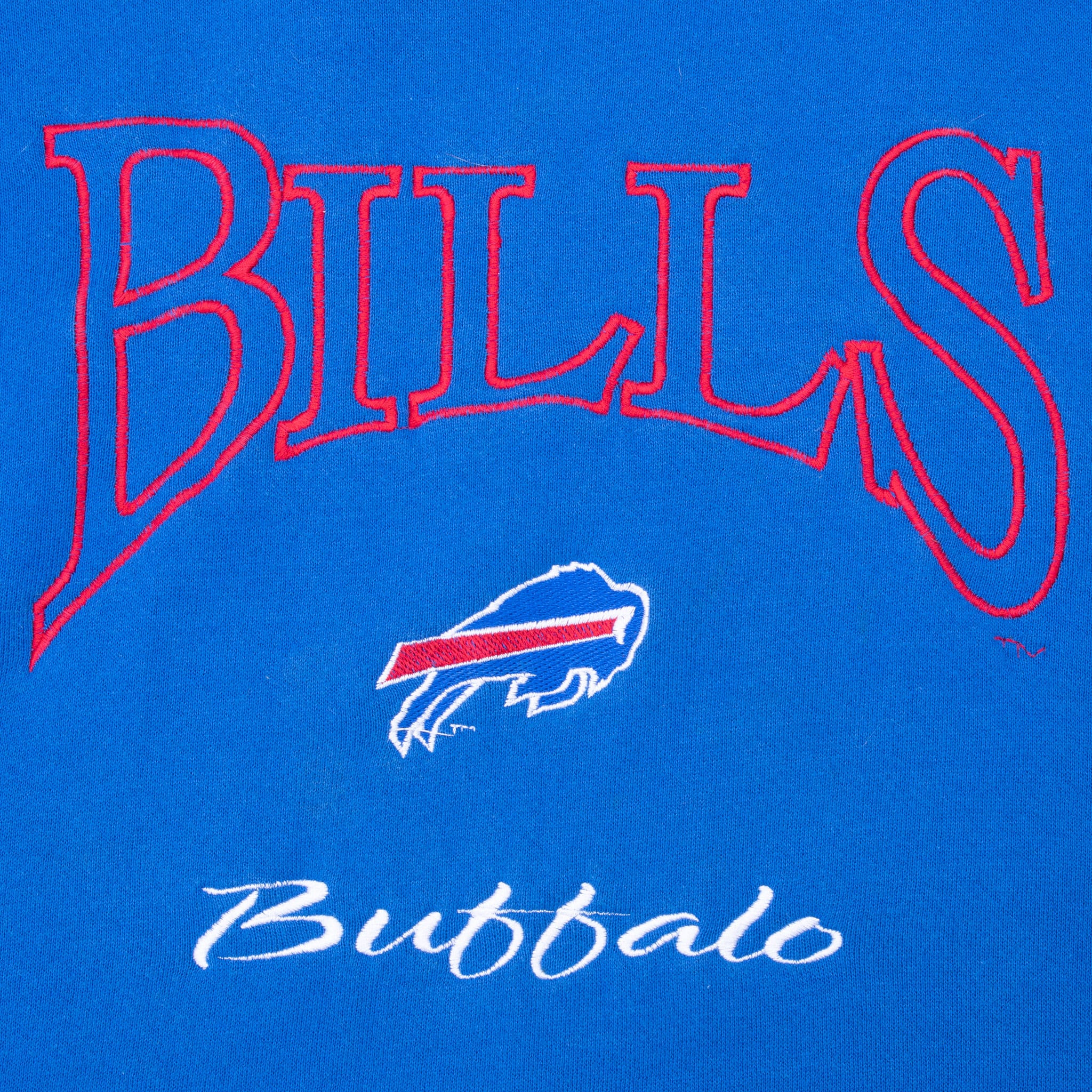 Close-up of embroidered Bills lettering, charging buffalo logo and Buffalo script