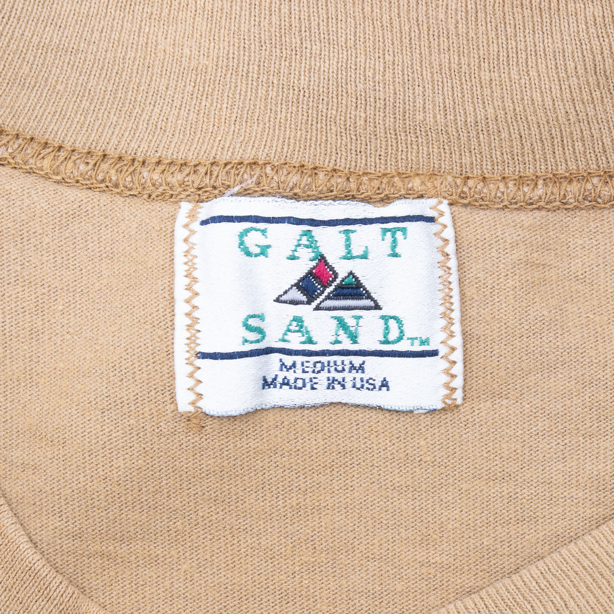 Galt Sand medium Made in USA neck label on tan T-shirt