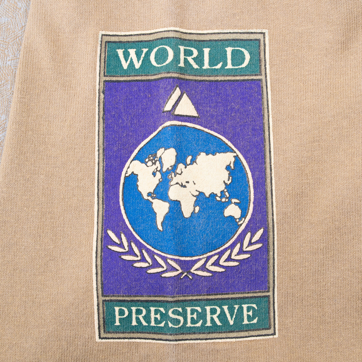 World Preserve sleeve graphic with globe and laurel design